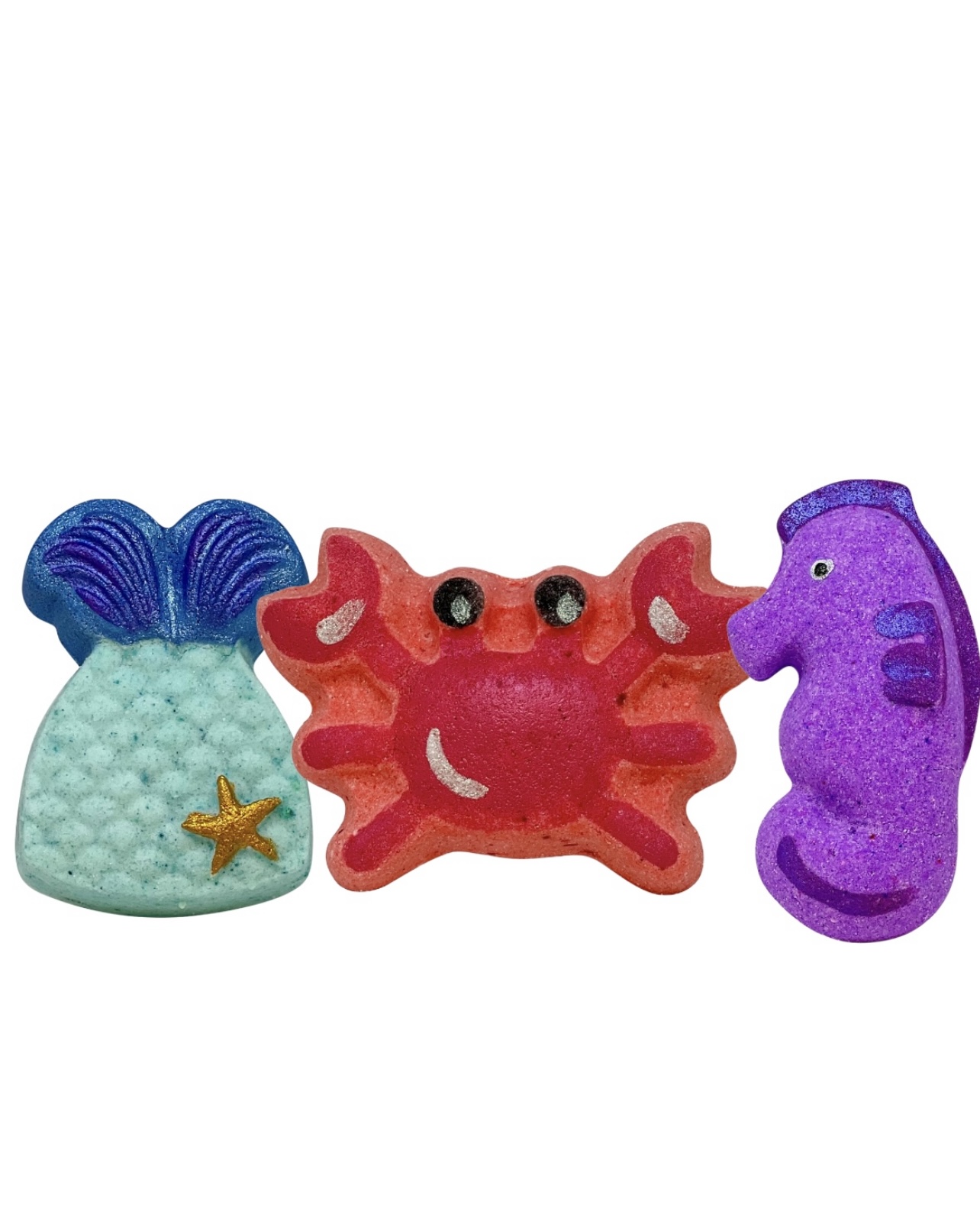 A colorful set of three Under the Sea bath bombs, featuring a mermaid tail, a horse, and a crab design, each with vibrant colors and unique scents.