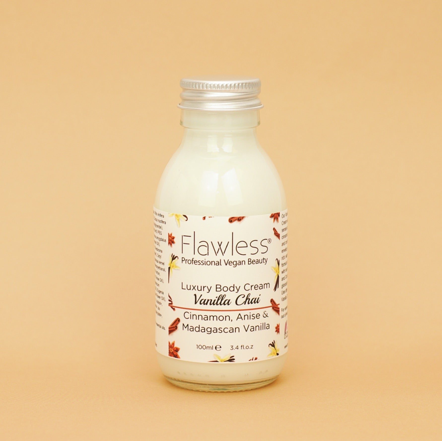 A jar of Vanilla Chai Body Cream with a creamy texture, surrounded by cinnamon sticks and vanilla pods, showcasing its nourishing ingredients.