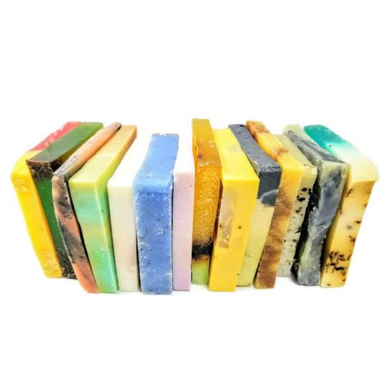 A beautifully arranged Vegan Soap Sampler featuring assorted slices of colorful soap loaf ends tied with a ribbon.