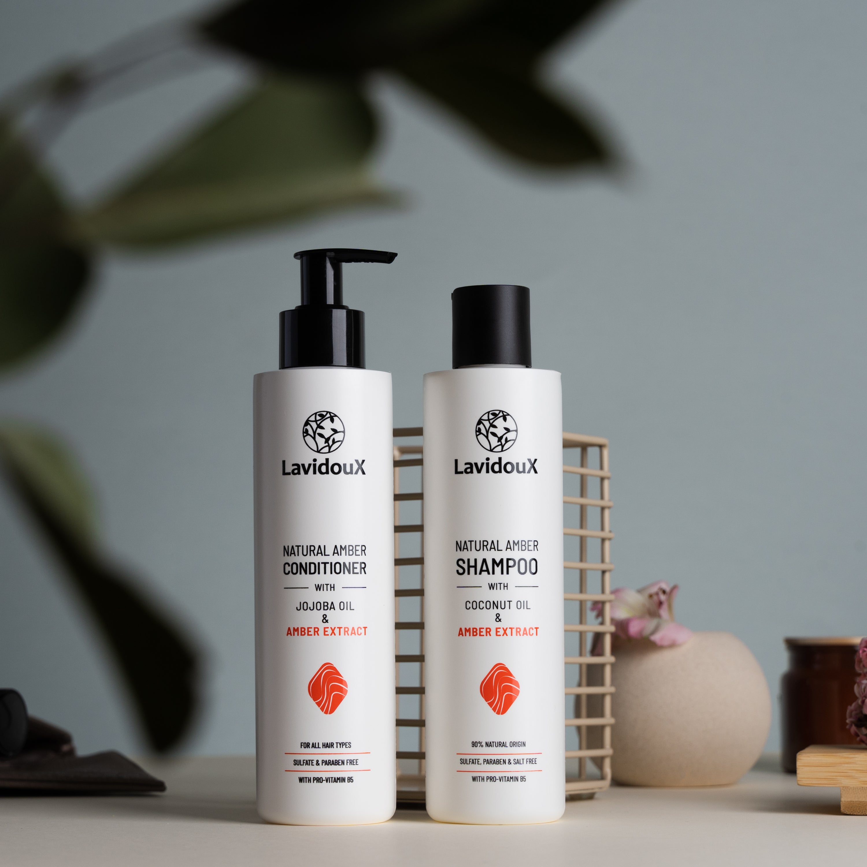 Amber Shampoo and Conditioner Set with natural ingredients in 250 ml bottles, featuring Amber extract and Coconut Oil.