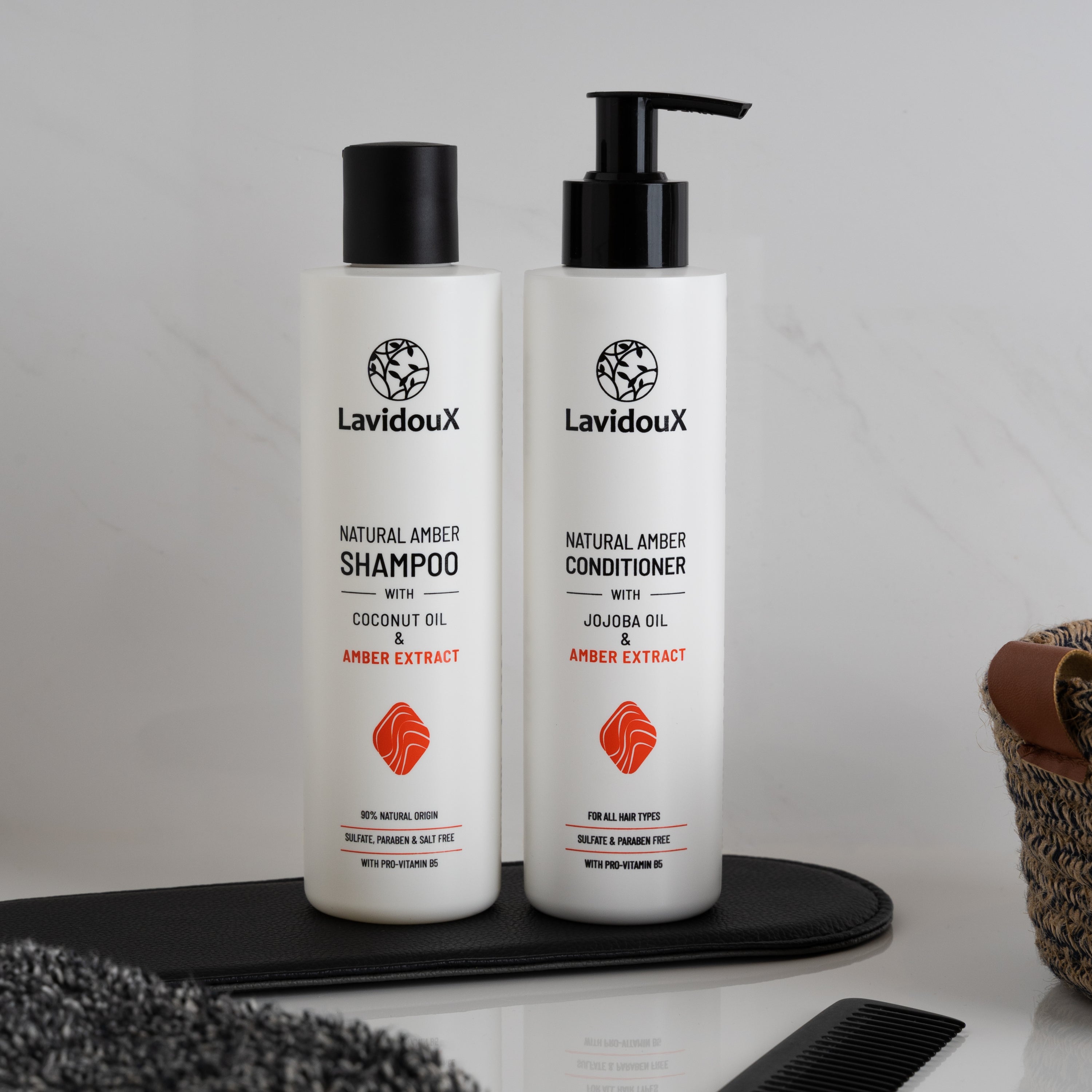 Amber Shampoo and Conditioner Set with natural ingredients in 250 ml bottles, featuring Amber extract and Coconut Oil.