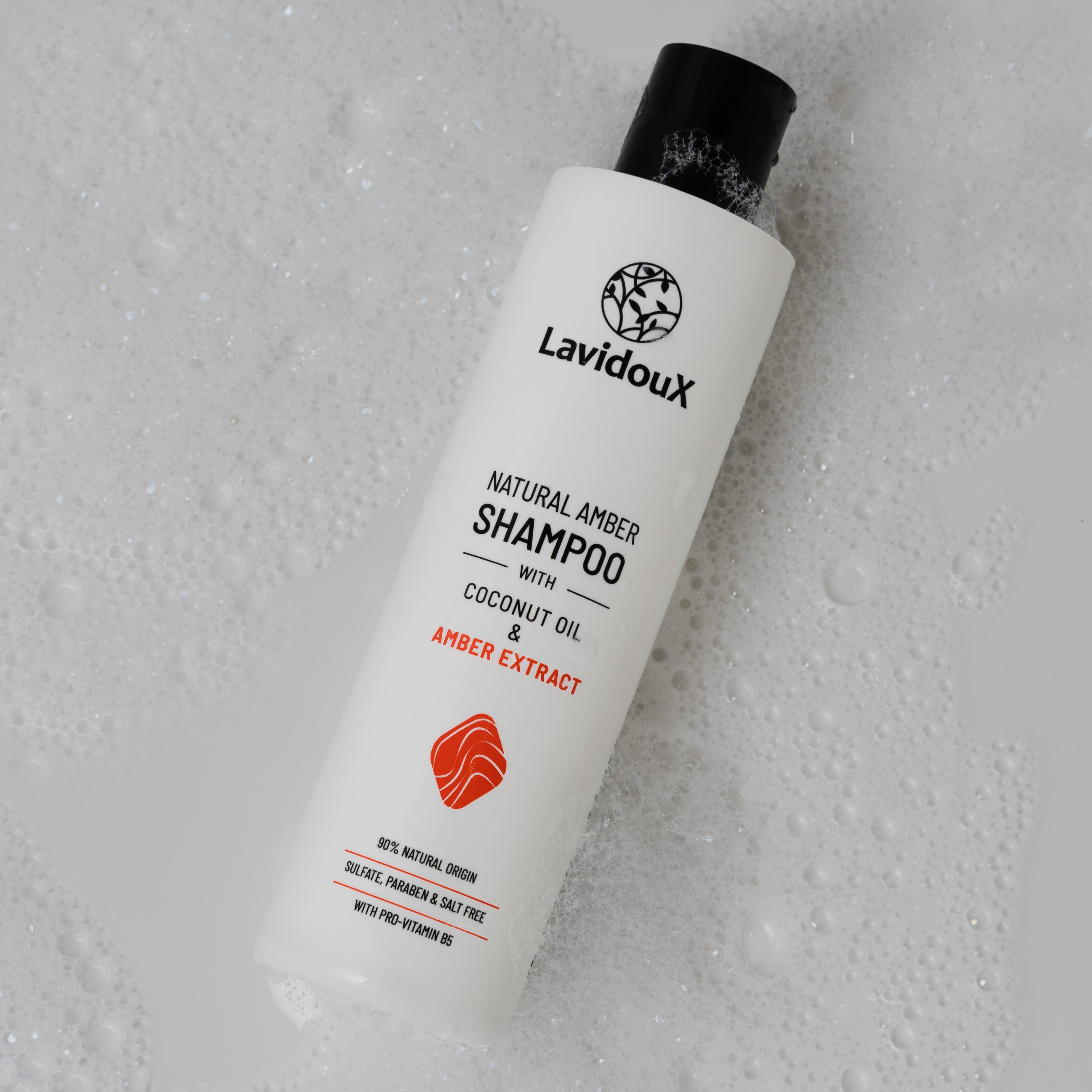 Bottle of Amber Shampoo with natural ingredients, featuring amber extract and coconut oil, designed for soft and healthy hair.