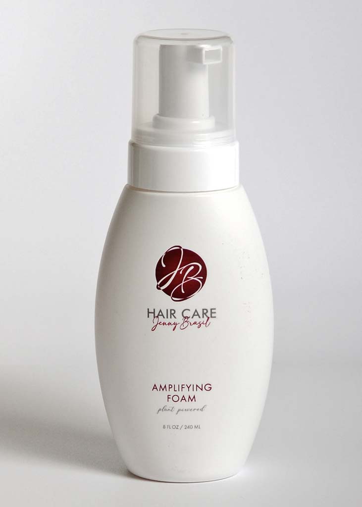 A bottle of Amplifying Foam with a sleek design, showcasing its lightweight formula for boosting hair volume.