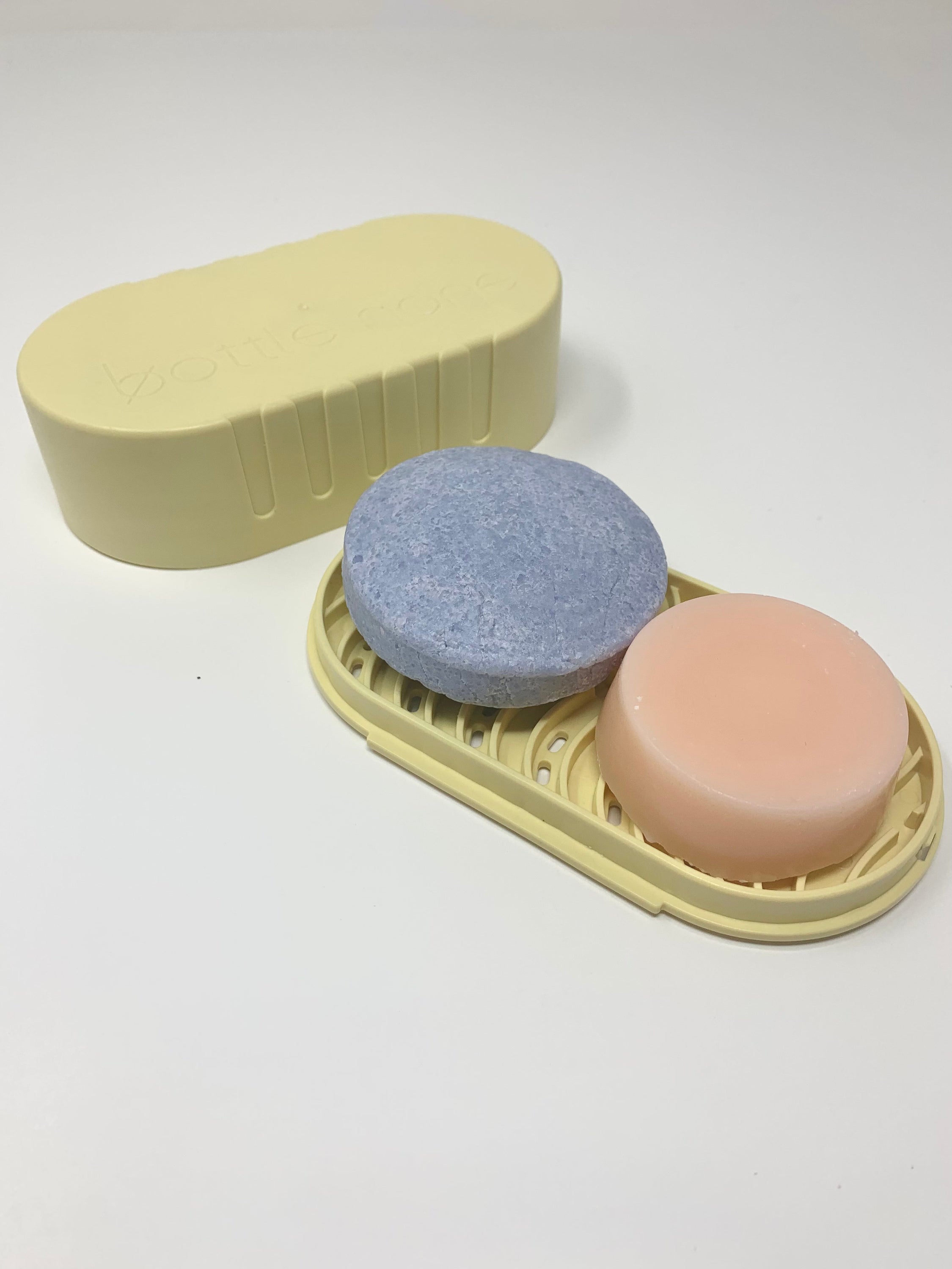 BEACH VIBES-Island Sunrise Travel Set featuring shampoo and conditioner bars with a tropical pineapple-mocktail scent, packaged in a recycled travel case.