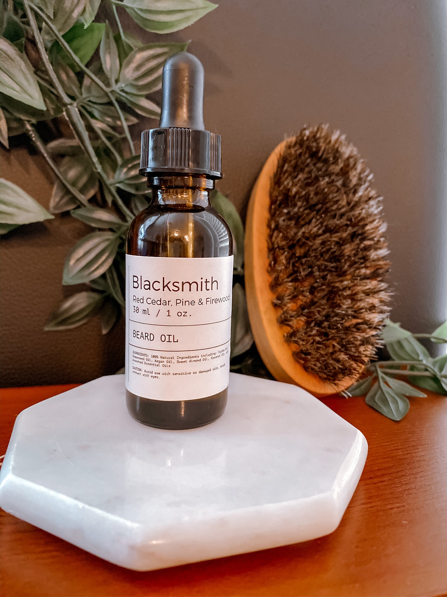 Bottle of Blacksmith Beard Oil with a woodsy scent, featuring a sleek design and natural ingredients.