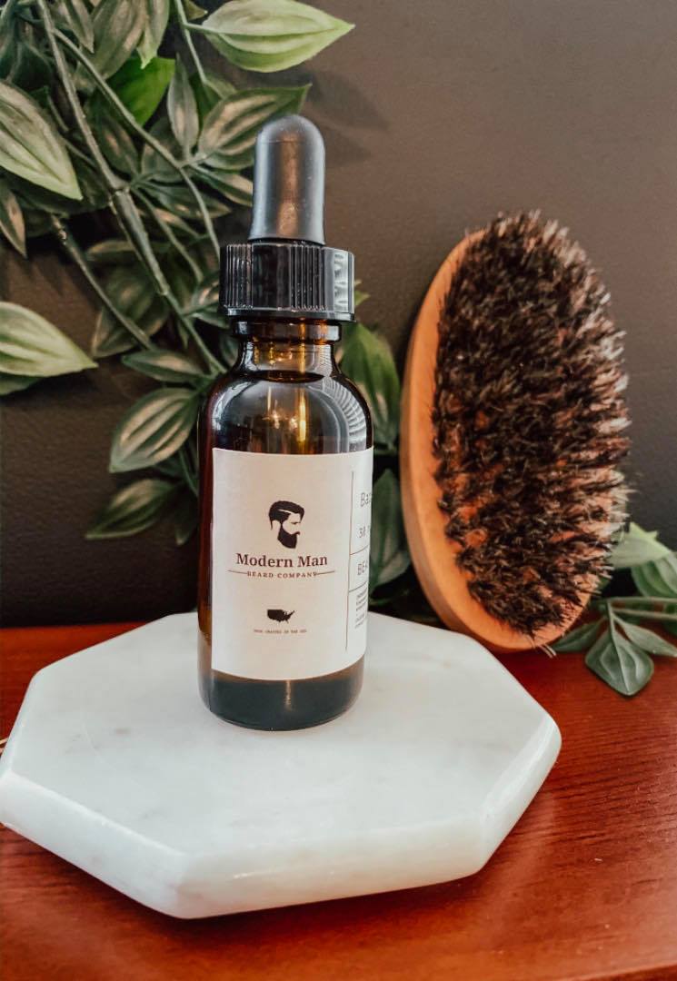 Bottle of Blacksmith Beard Oil with a woodsy scent, featuring a sleek design and natural ingredients.