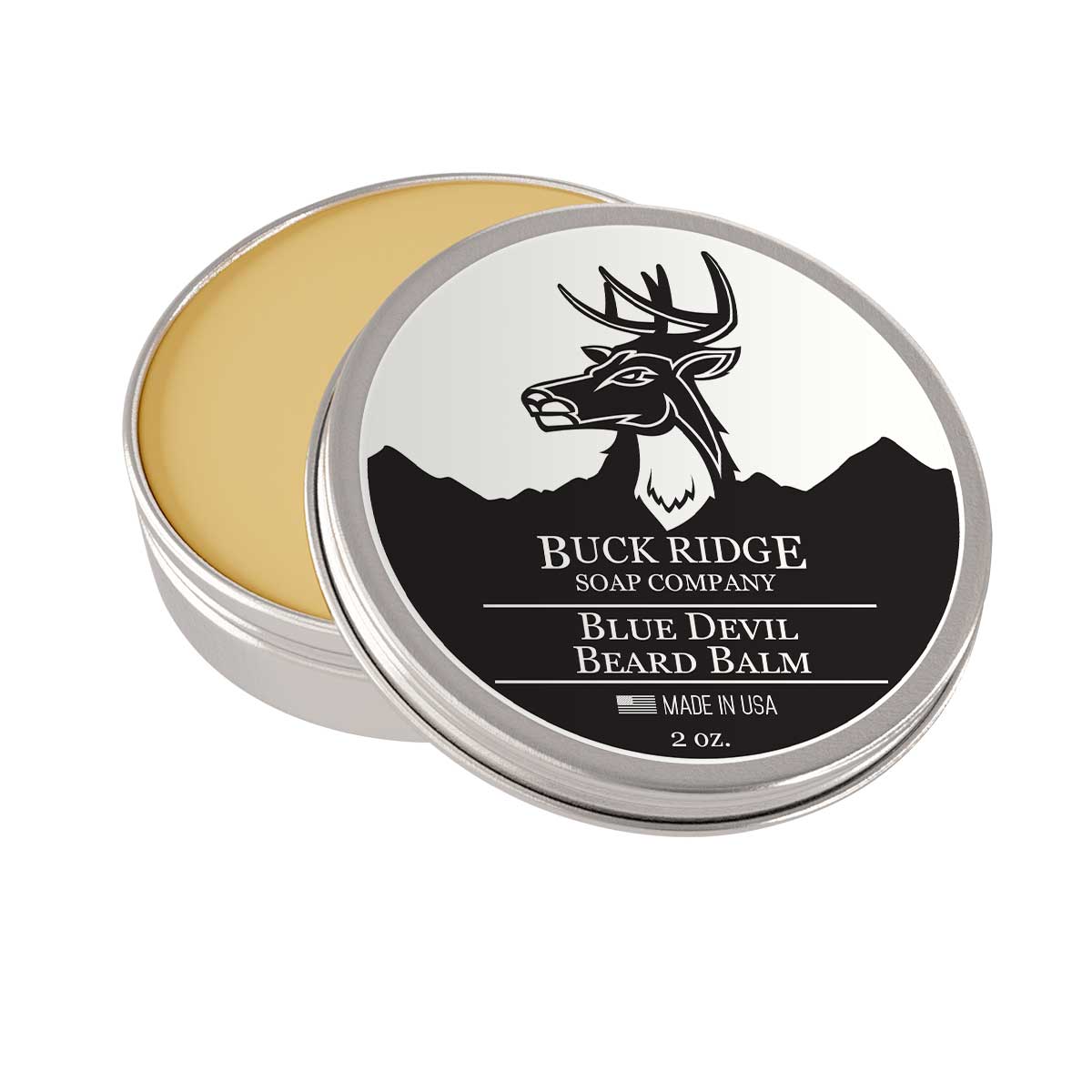 A silver tin of Blue Devil Beard Balm by Buck Ridge Soap Company, showcasing its smoky and spicy scent ingredients like vetivert and amber.