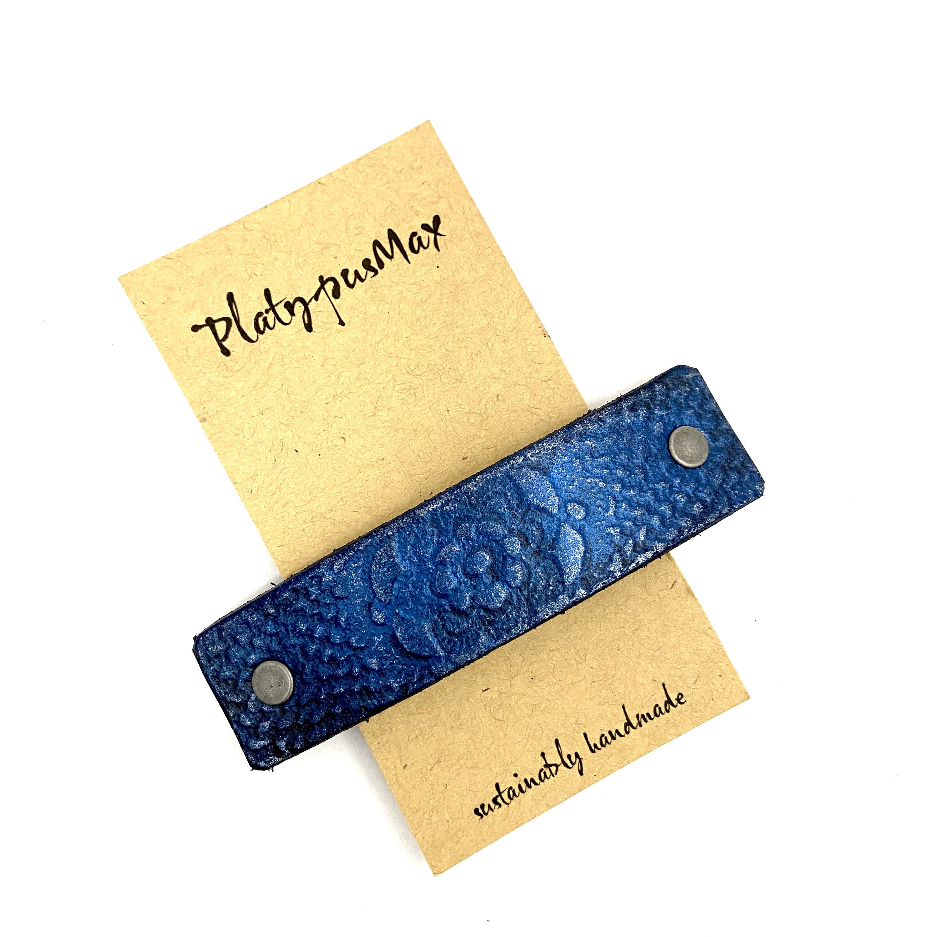 Brilliant Blue Lace Flower Leather Hair Barrette with rustic flower pattern and metallic sheen, perfect for long hair.