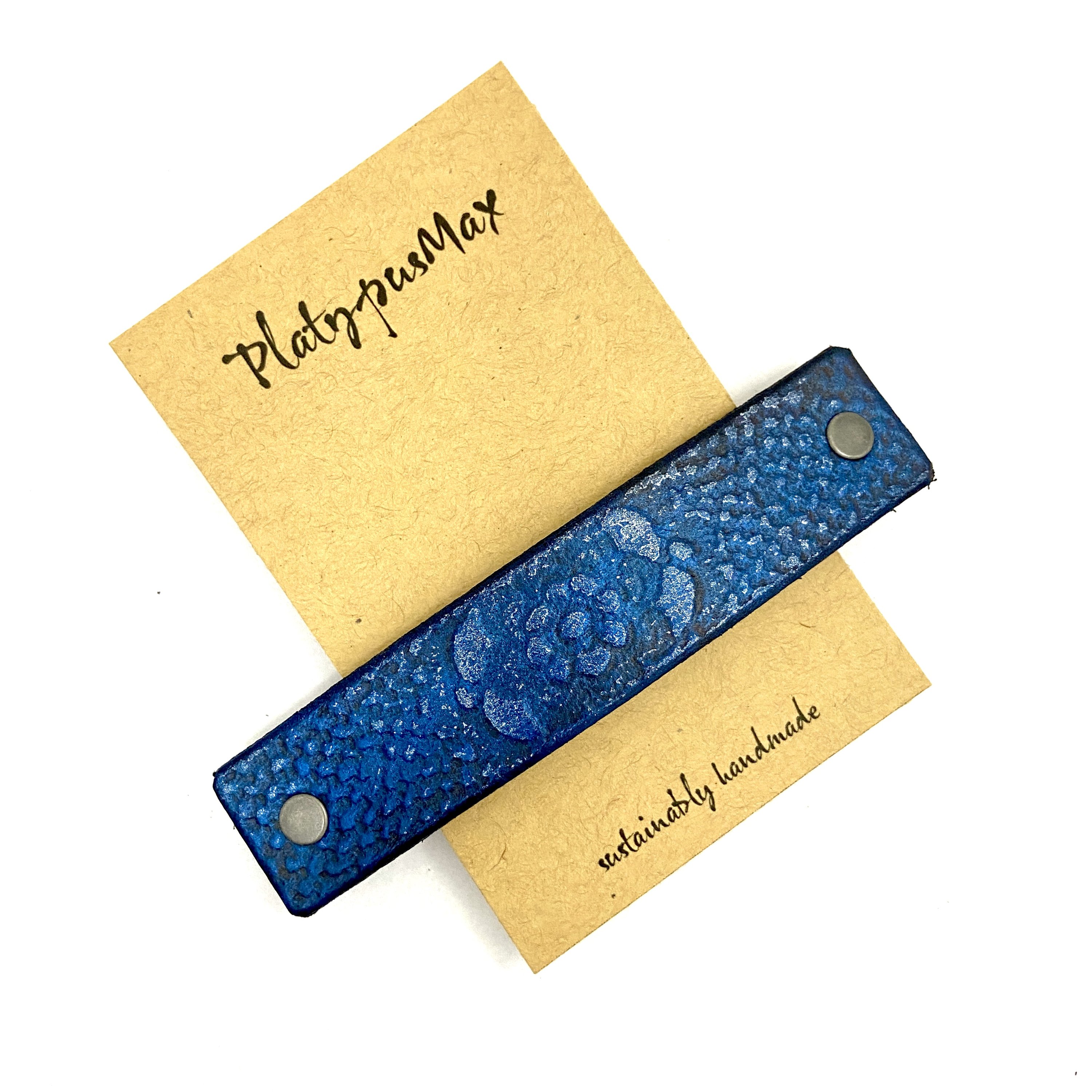 Brilliant Blue Lace Flower Leather Hair Barrette with rustic flower pattern and metallic sheen, perfect for long hair.