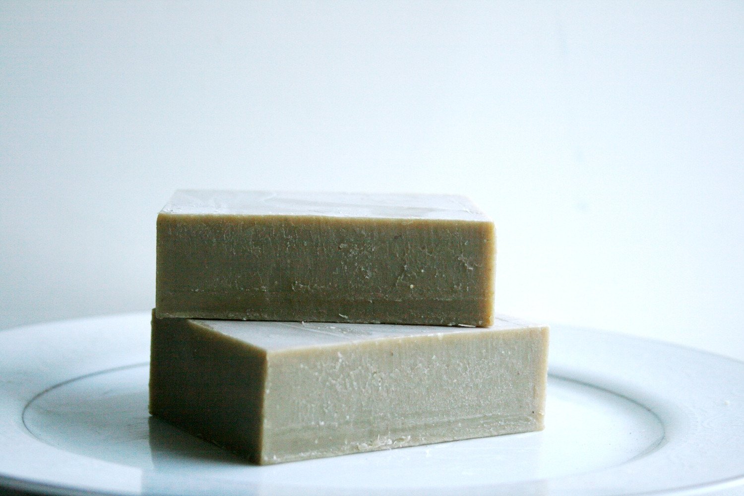 Dead Sea Mud Shampoo Bar with essential oils, showcasing its natural ingredients and earthy texture.