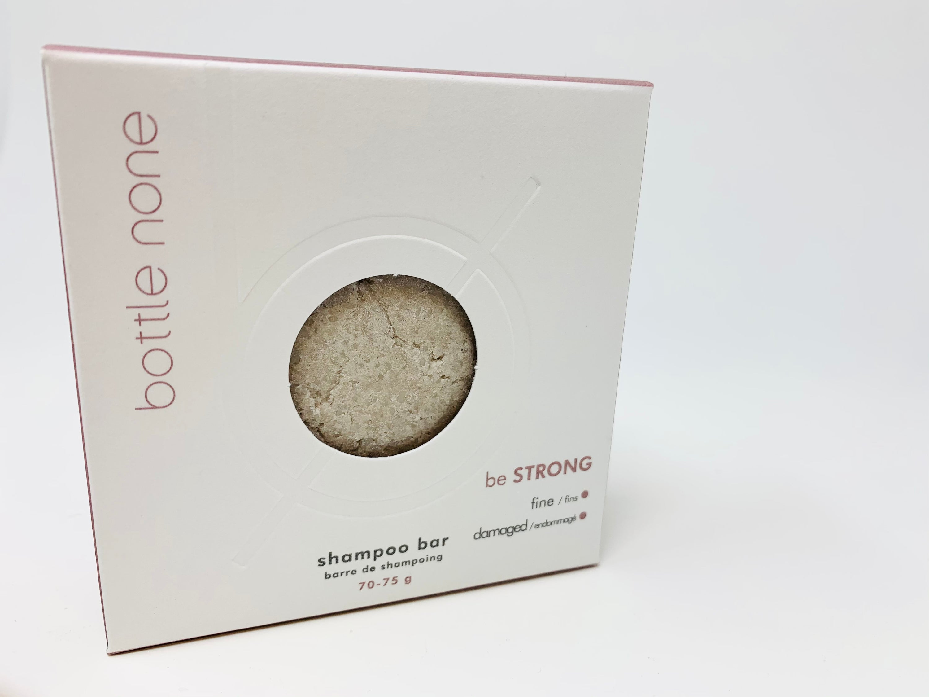 be STRONG Shampoo Bar in a stylish box, designed for fine and damaged hair, featuring natural ingredients like nettle and avocado oil.