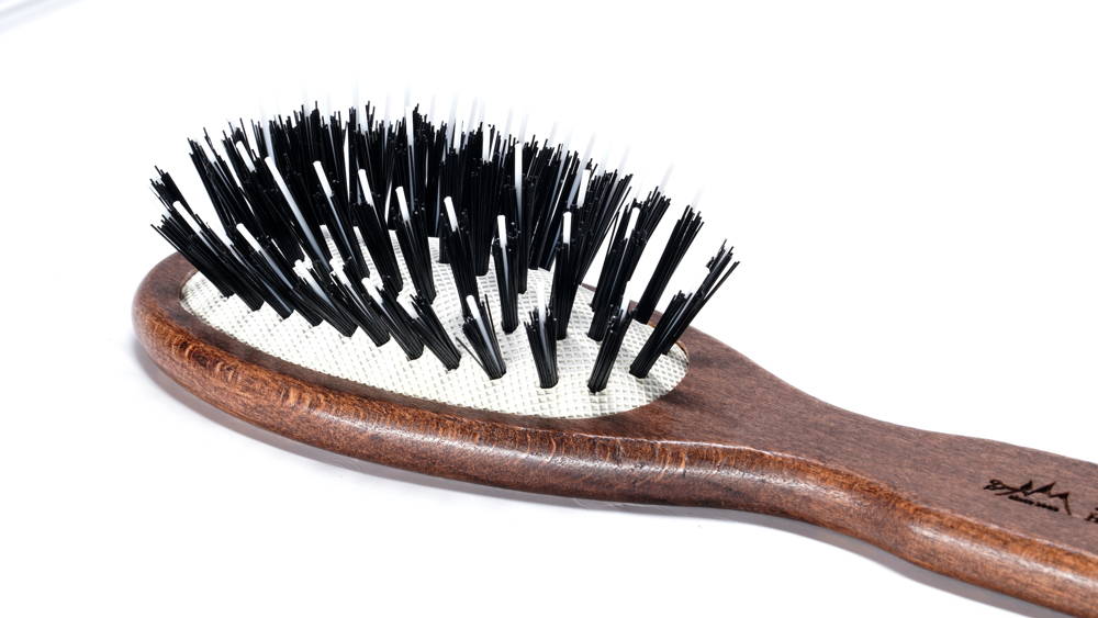 Hair Brush No. 01, a small wooden detangling brush designed for smooth hair, ideal for travel and children.