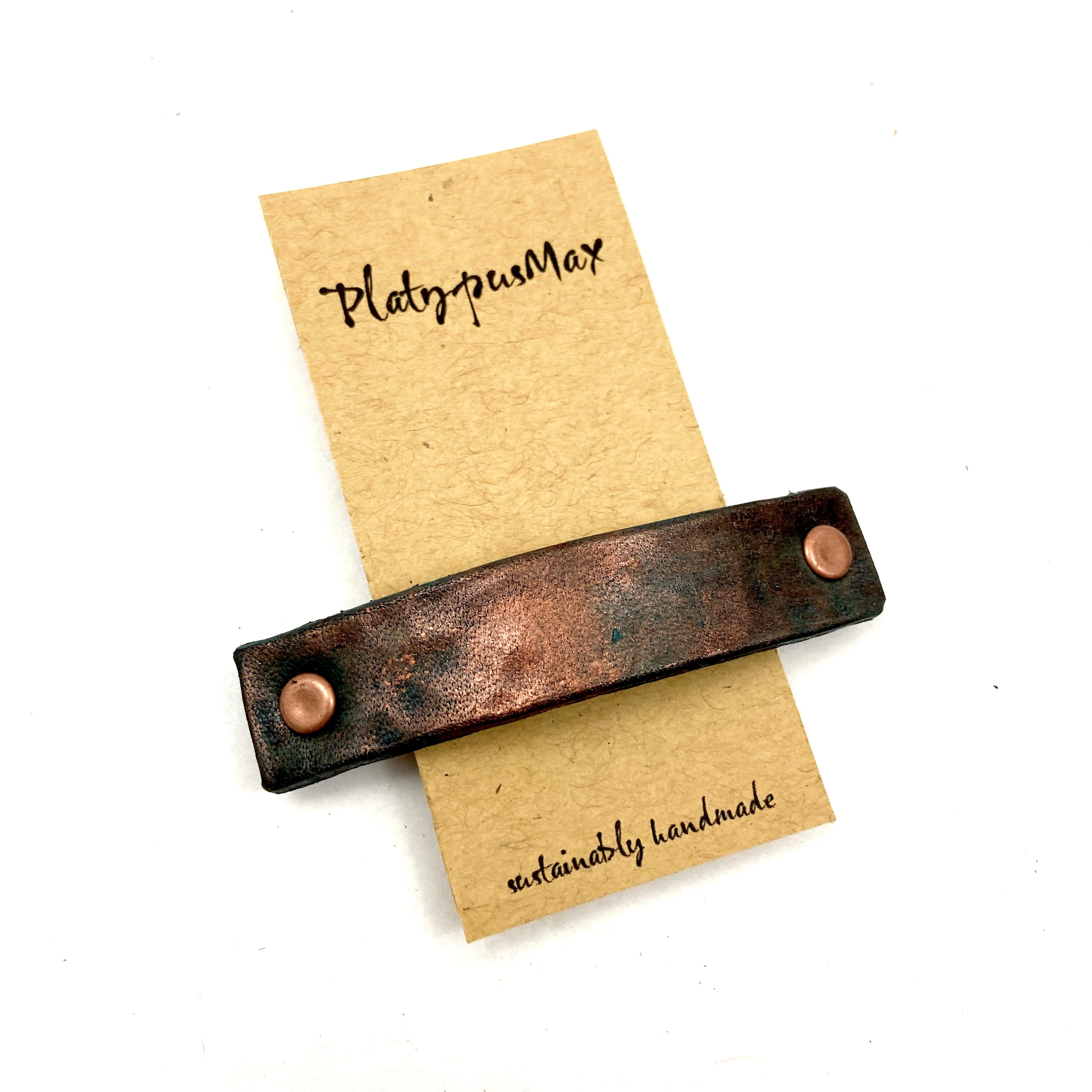 Hammered Antique Copper Leather Barrette featuring embossed leaf print in rich purple-red leather with metallic finish.