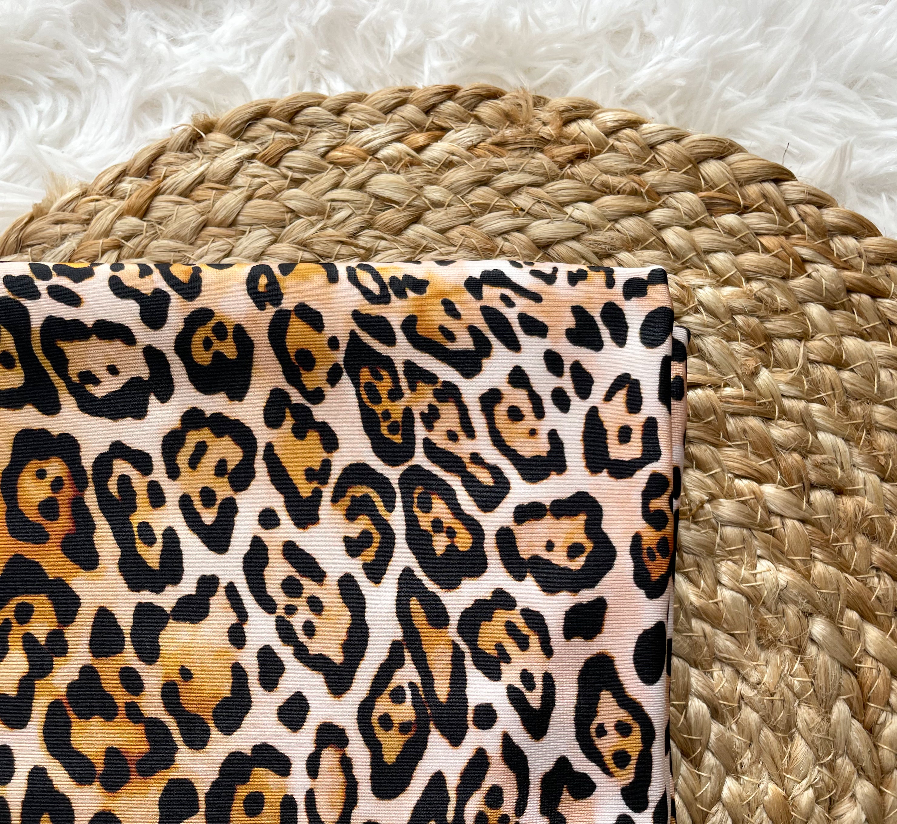 Leopard print swim scrunchie made of spandex, perfect for securing hair during water activities.