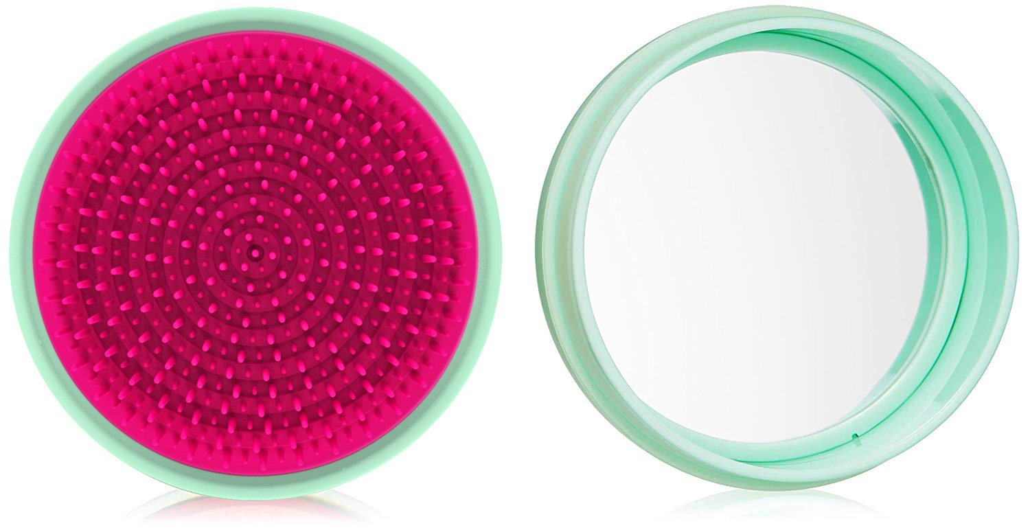 A stylish macaron for hair® travel hairbrush with a pop-off cover and integrated mirror, designed for easy detangling and portability.