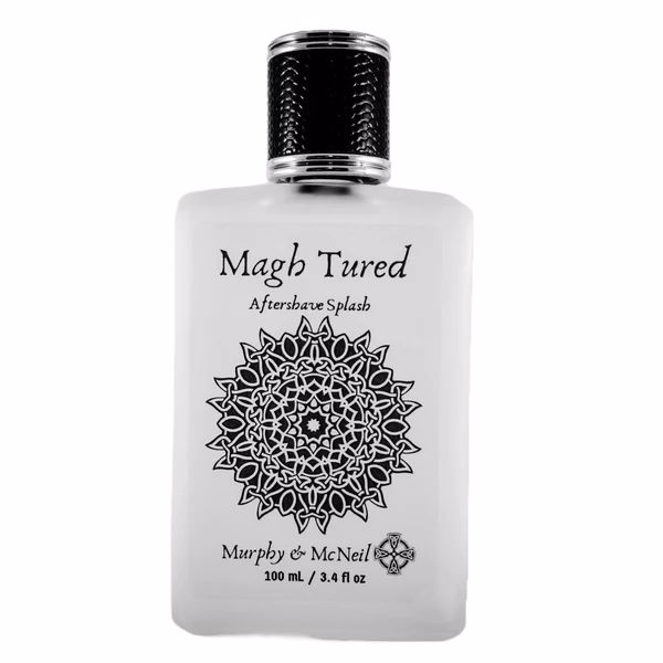 Magh Tured Aftershave Splash by Murphy and McNeil, featuring a sleek bottle design with a dark label and earthy tones, symbolizing its spicy and woody fragrance.