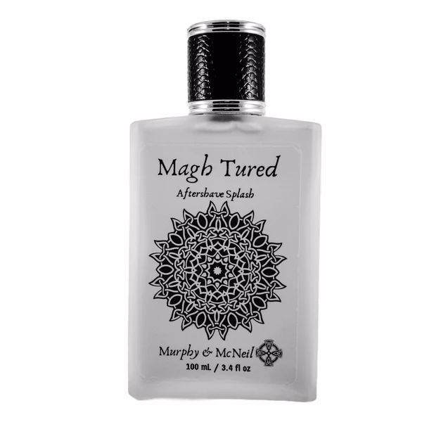 Magh Tured Aftershave Splash by Murphy and McNeil, featuring a sleek bottle design with a dark label and earthy tones, symbolizing its spicy and woody fragrance.