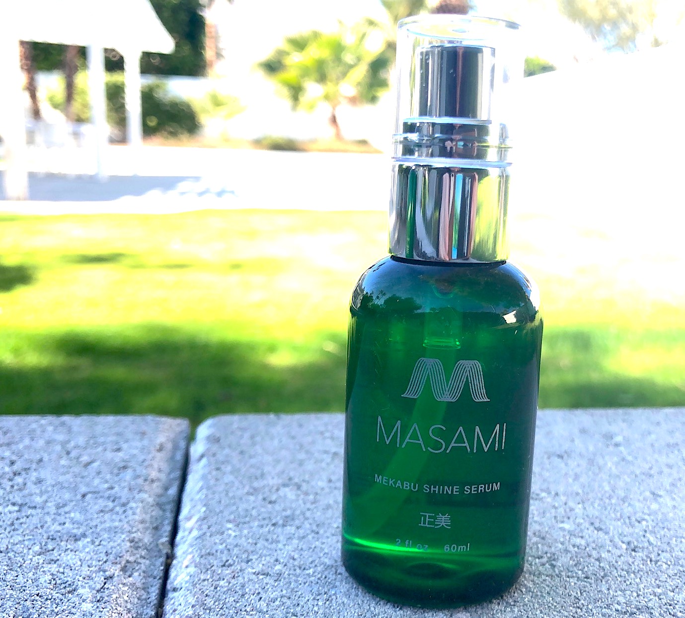 Mekabu Hydrating Shine Serum bottle with a sleek design, showcasing its nourishing properties for hair care.