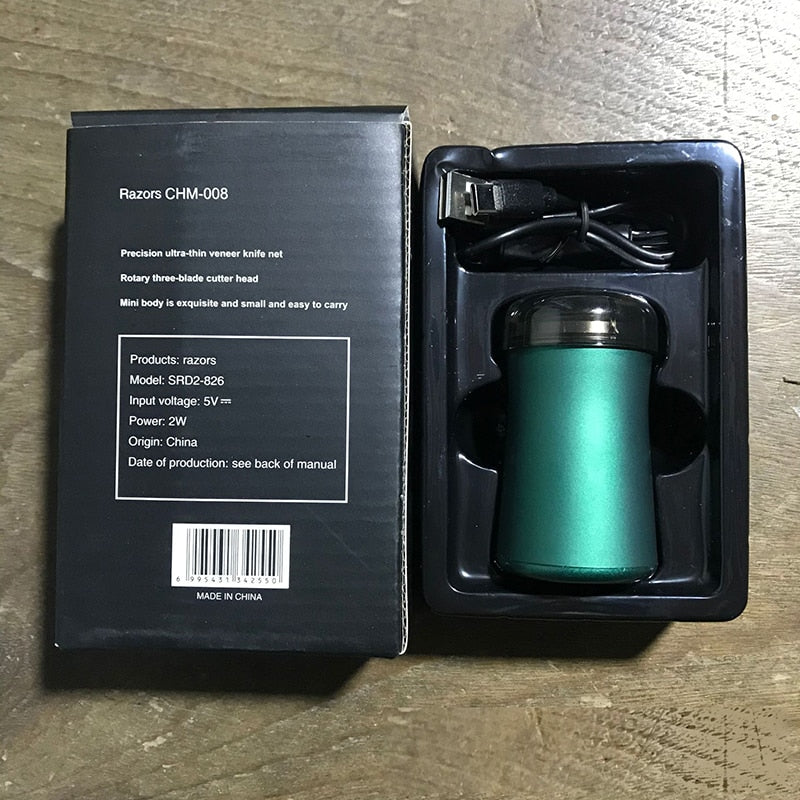 Mini Portable Hair Trimmer Electric Shaver Razor in green and black, showcasing its compact design and USB charging port.