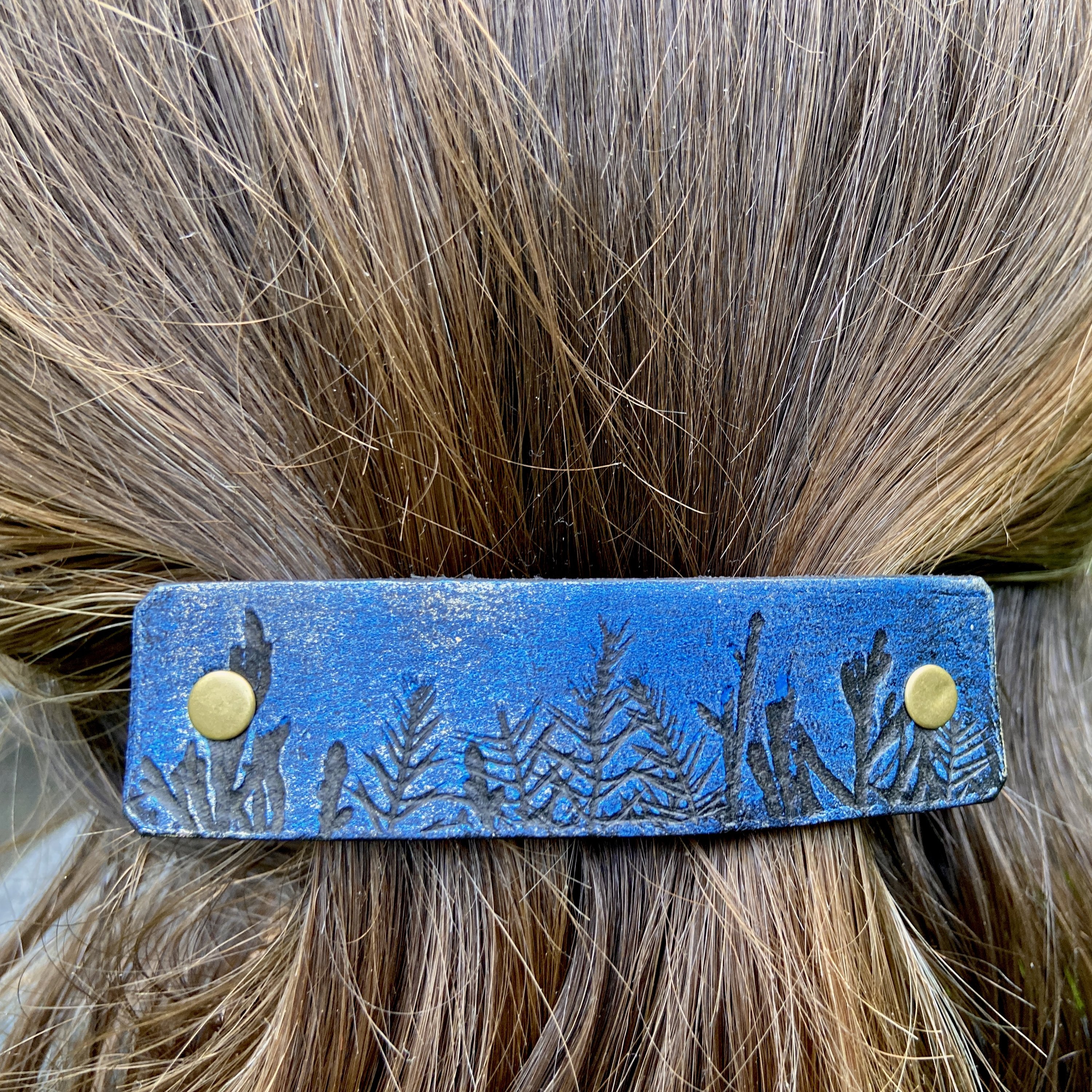 Moonlit Forest Trees Blue & Gold Leather Hair Barrette featuring a unique design inspired by a pine forest at night with shimmering gold accents.