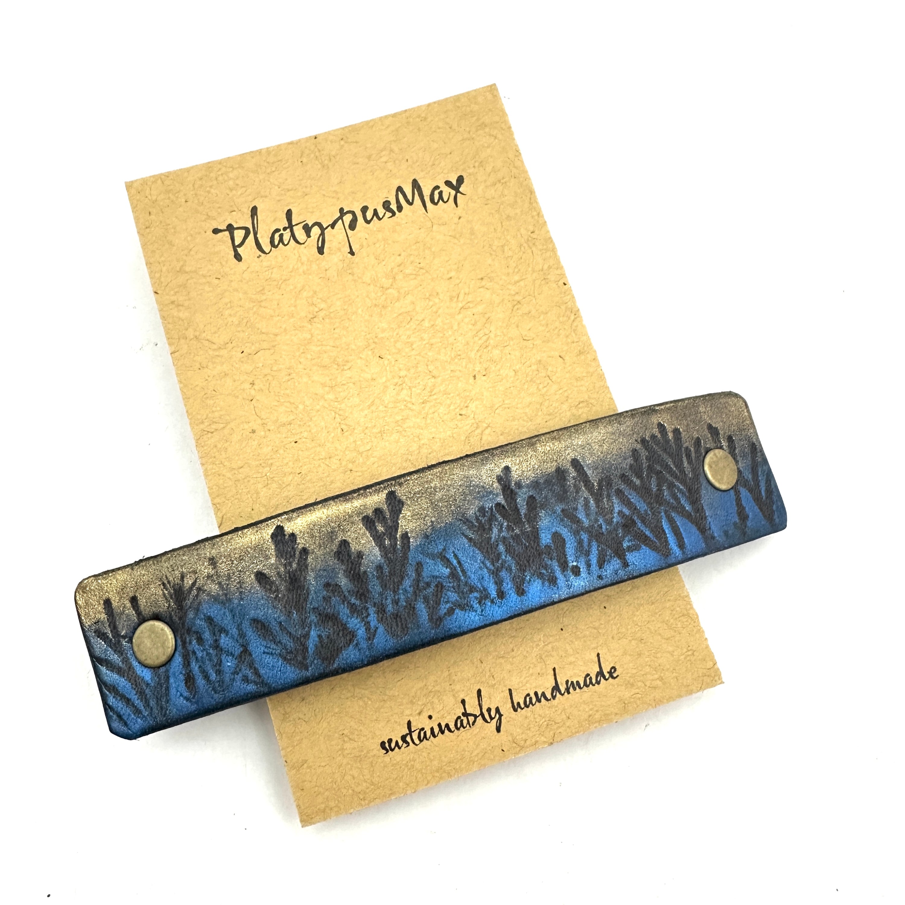 Moonlit Forest Trees Blue & Gold Leather Hair Barrette featuring a unique design inspired by a pine forest at night with shimmering gold accents.