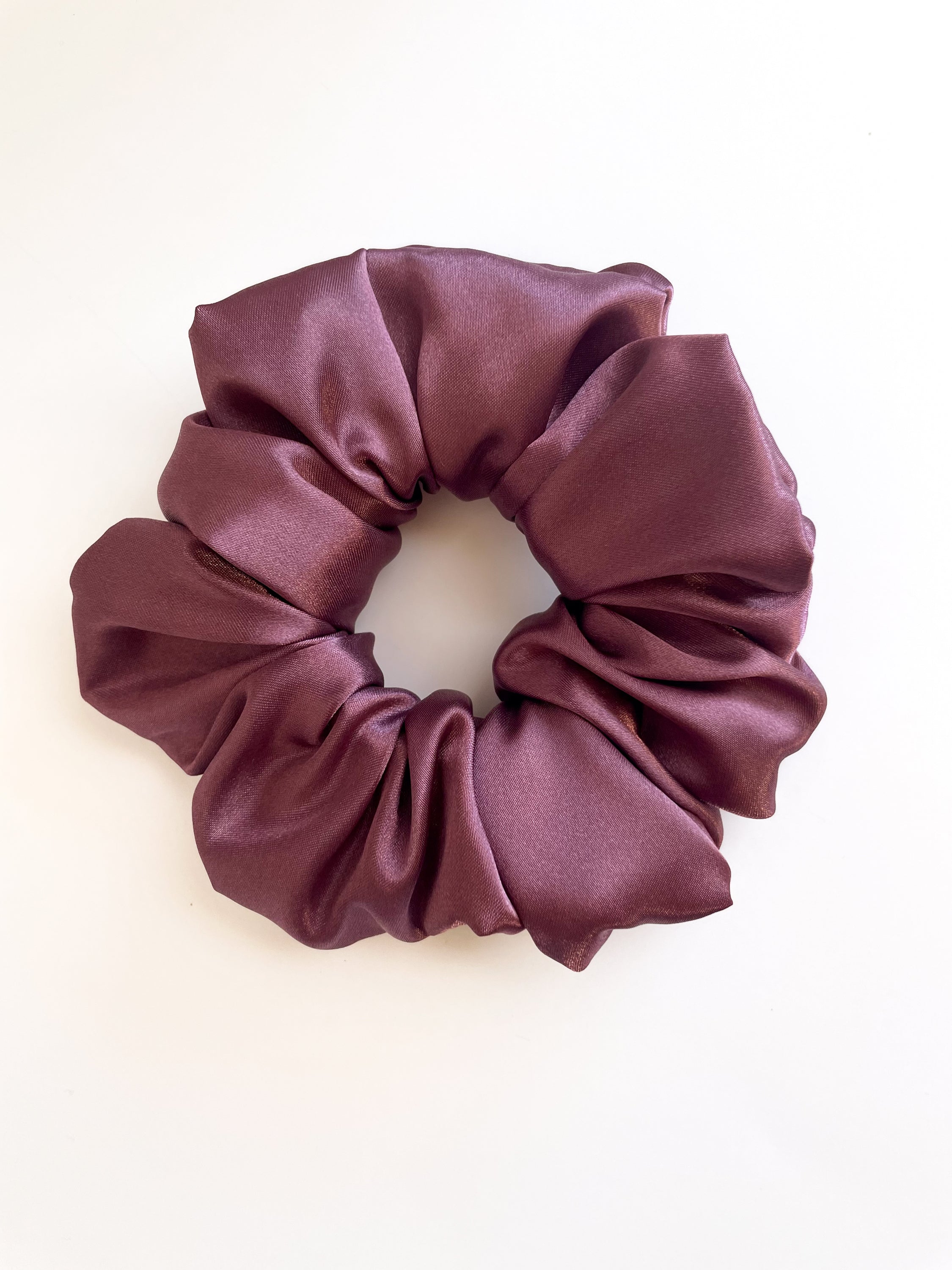 A luxurious mulberry satin scrunchie, elegantly styled and perfect for hair accessories.