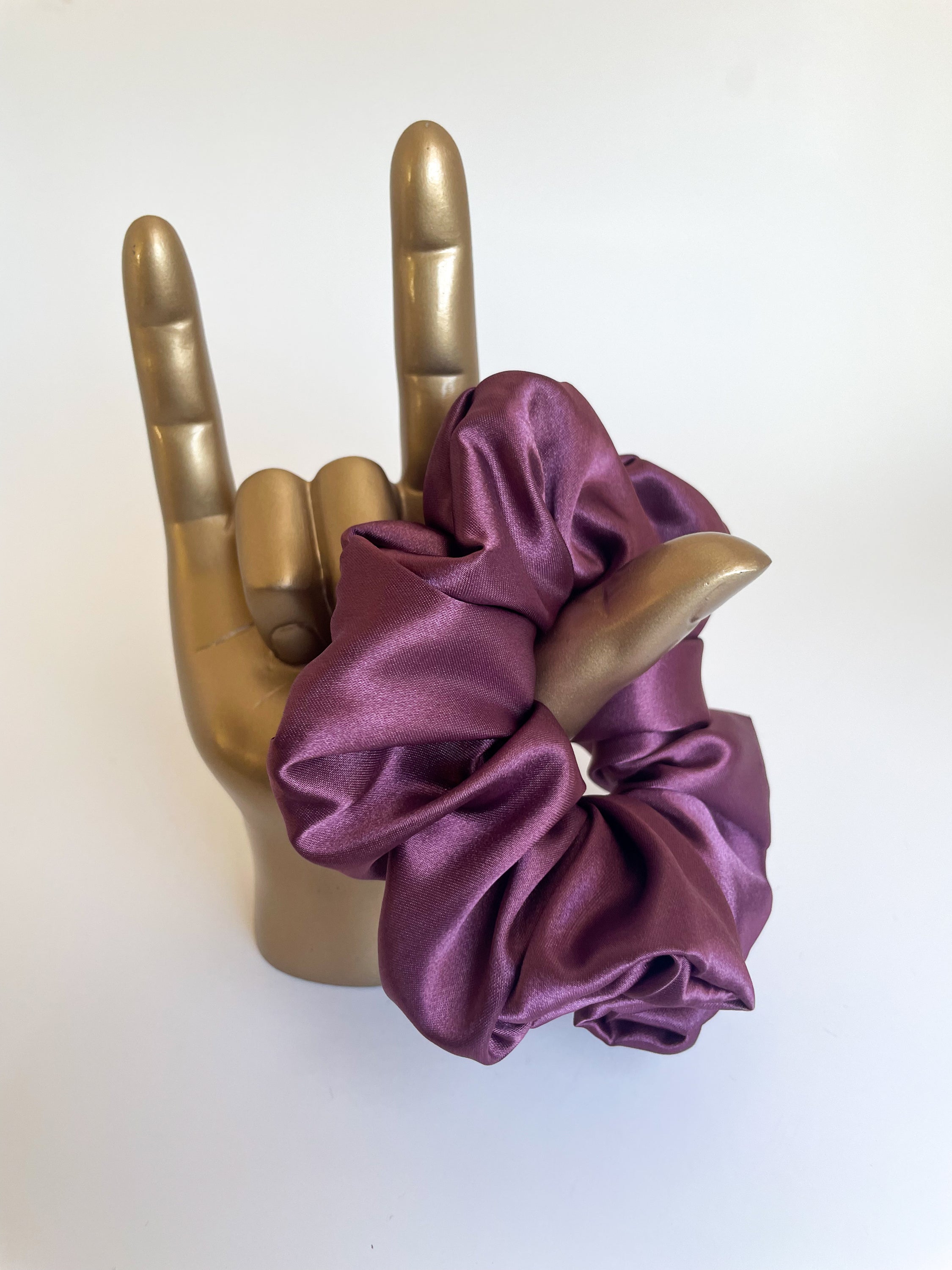 A luxurious mulberry satin scrunchie, elegantly styled and perfect for hair accessories.