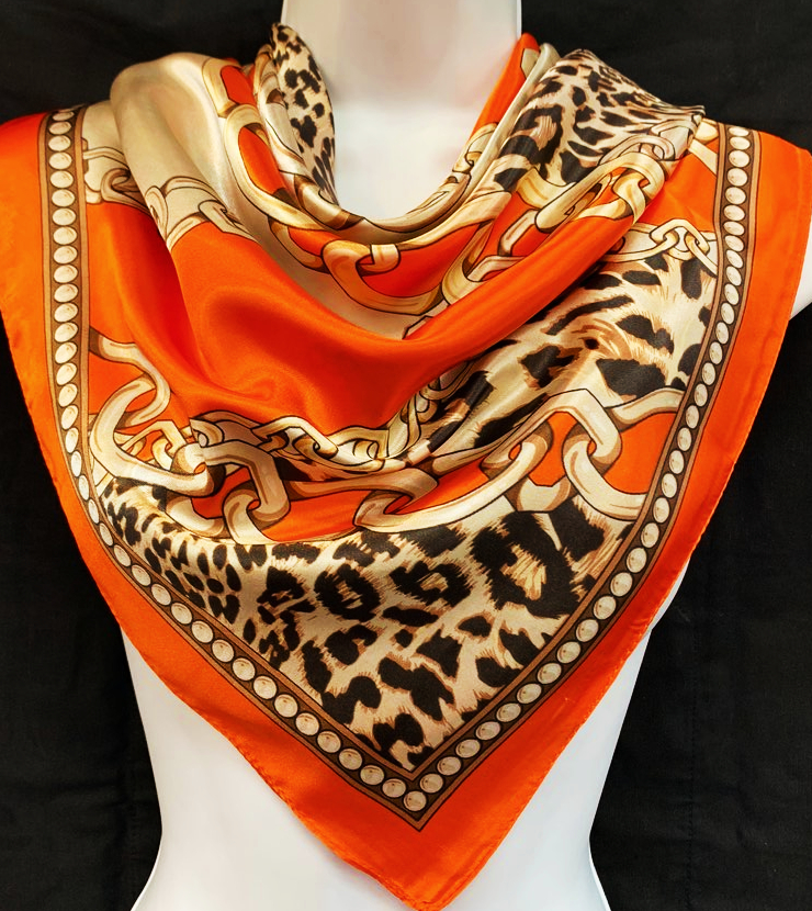 A luxurious 35" x 35" Multi Purpose Satin Scarf in vibrant colors, showcasing its silky texture and versatility for hair and fashion.