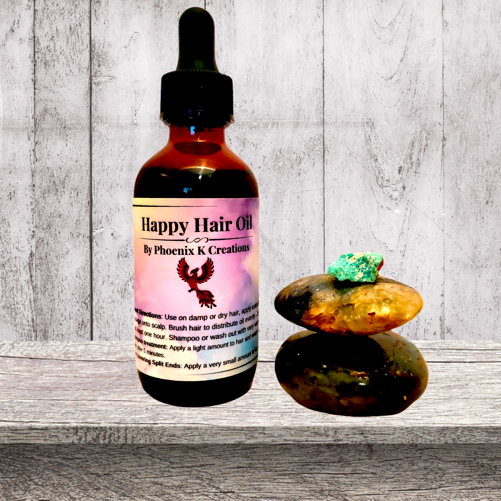 Organic Happy Hair Oil in a glass bottle with a dropper, surrounded by fresh herbs and flowers, showcasing its natural ingredients.