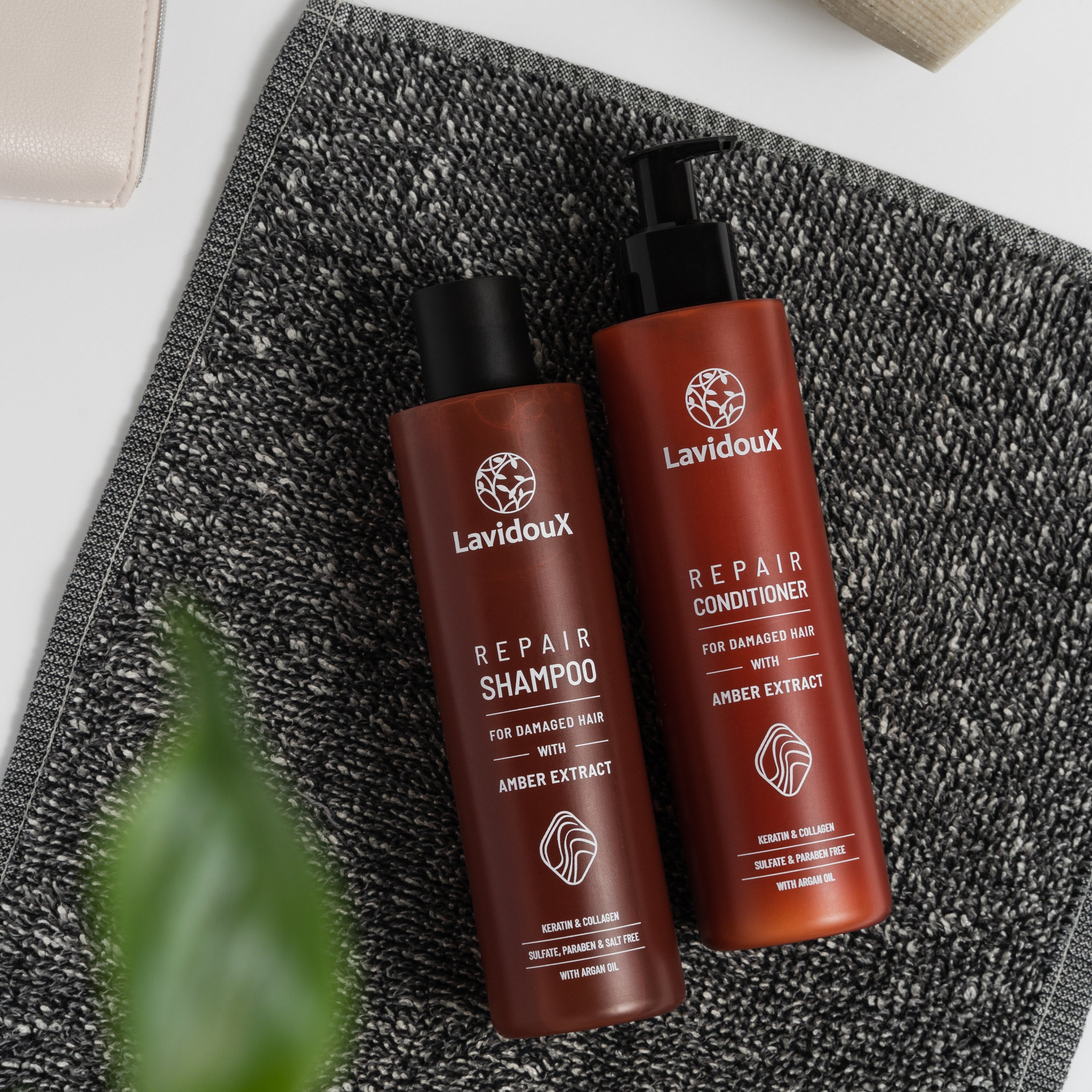 Repair Shampoo and Conditioner Set featuring Amber Extract and Argan Oil in elegant packaging, designed for damaged hair care.