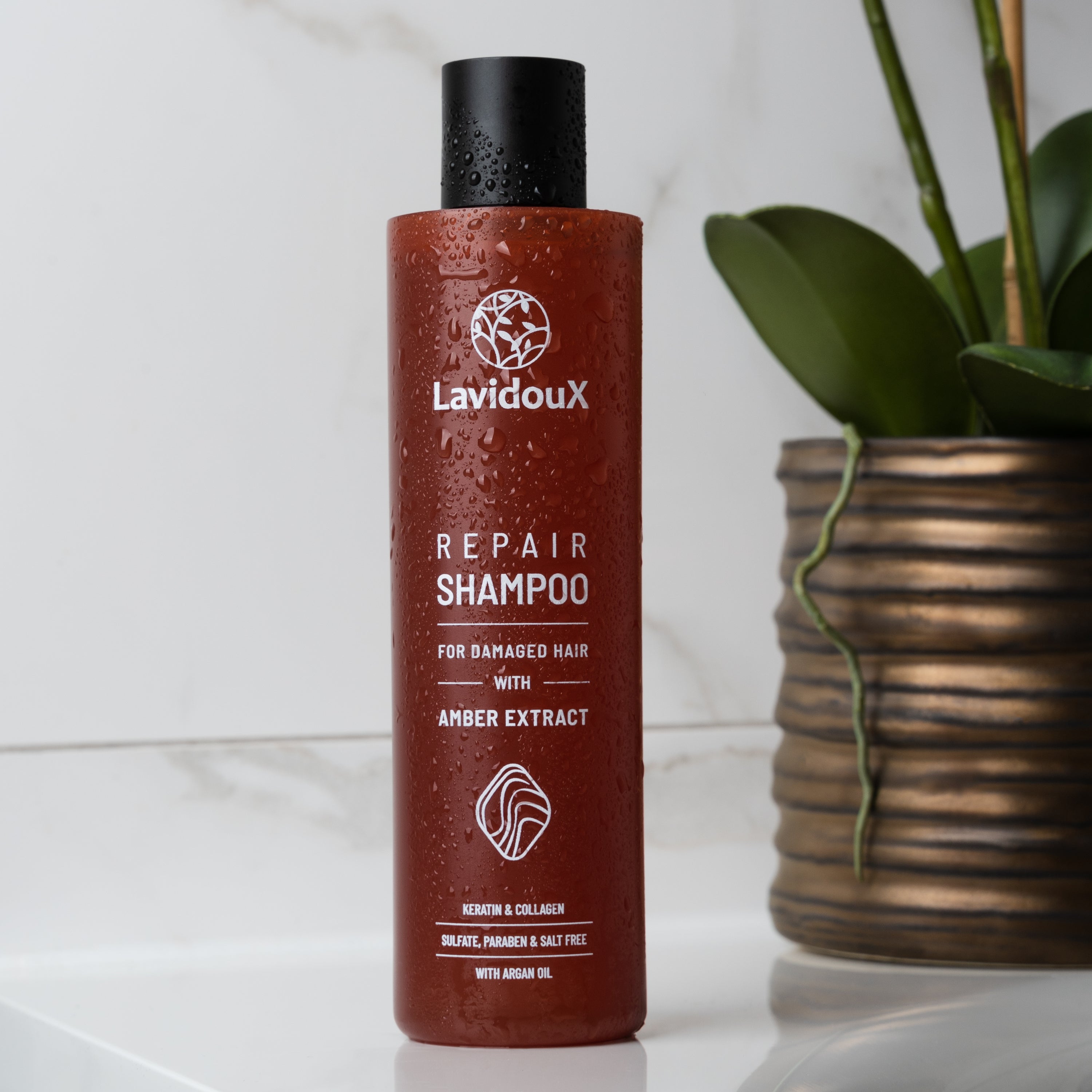 Repair Shampoo and Conditioner Set featuring Amber Extract and Argan Oil in elegant packaging, designed for damaged hair care.