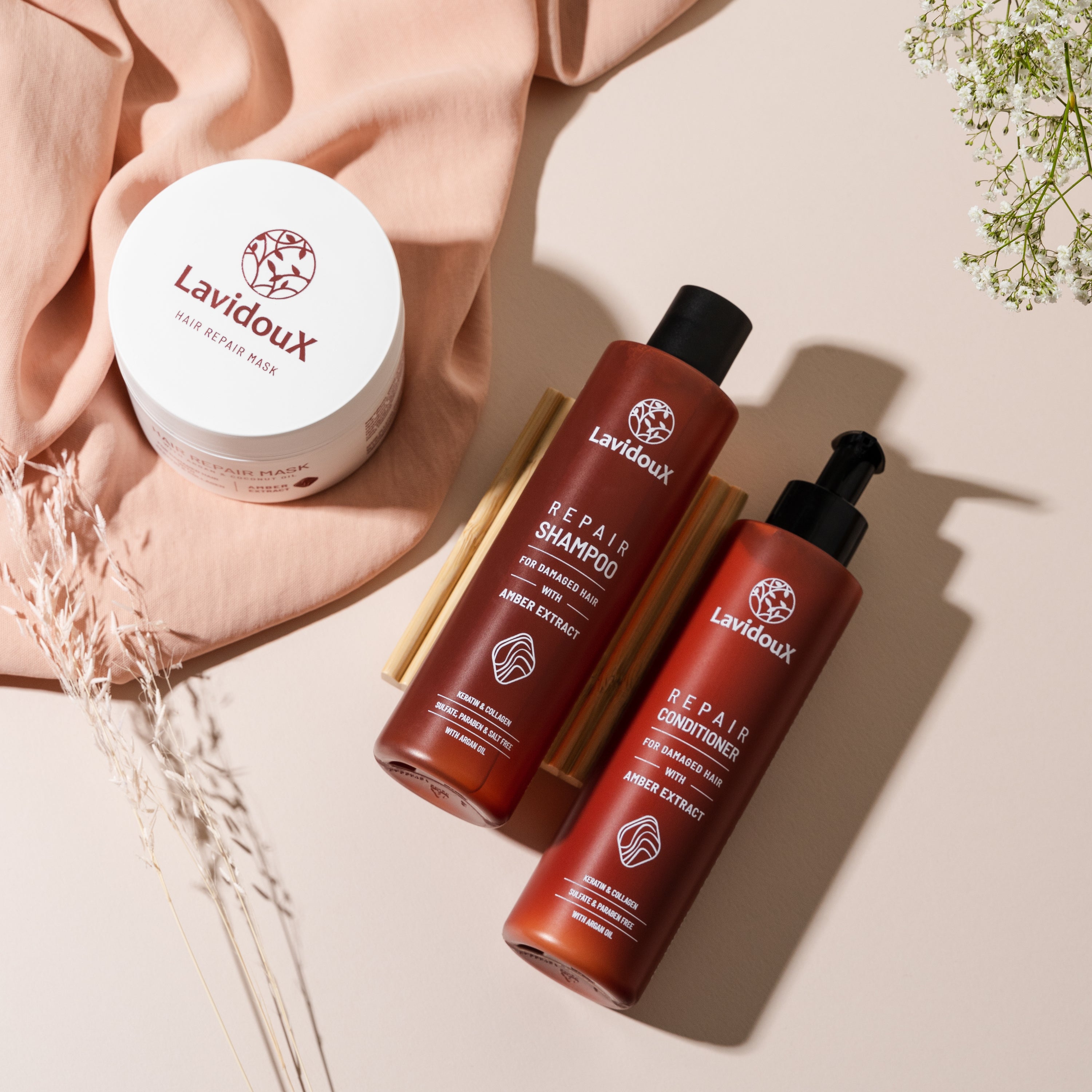 Repair Shampoo and Conditioner Set featuring Amber Extract and Argan Oil in elegant packaging, designed for damaged hair care.