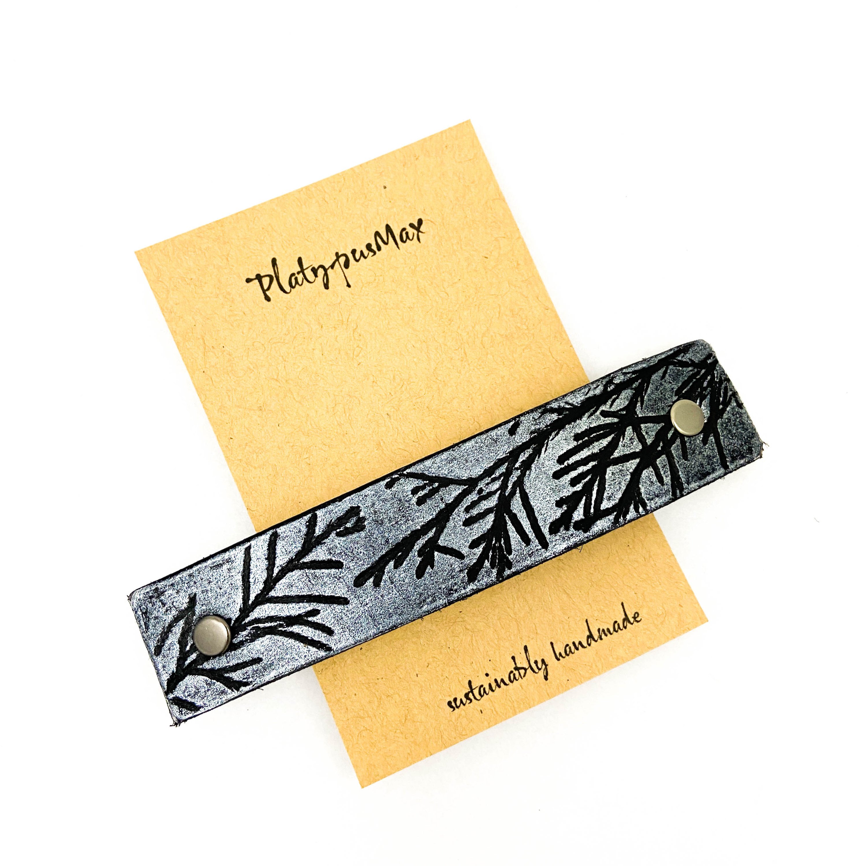 Silver Juniper Branches Leather Hair Barrette featuring embossed juniper designs on black leather.