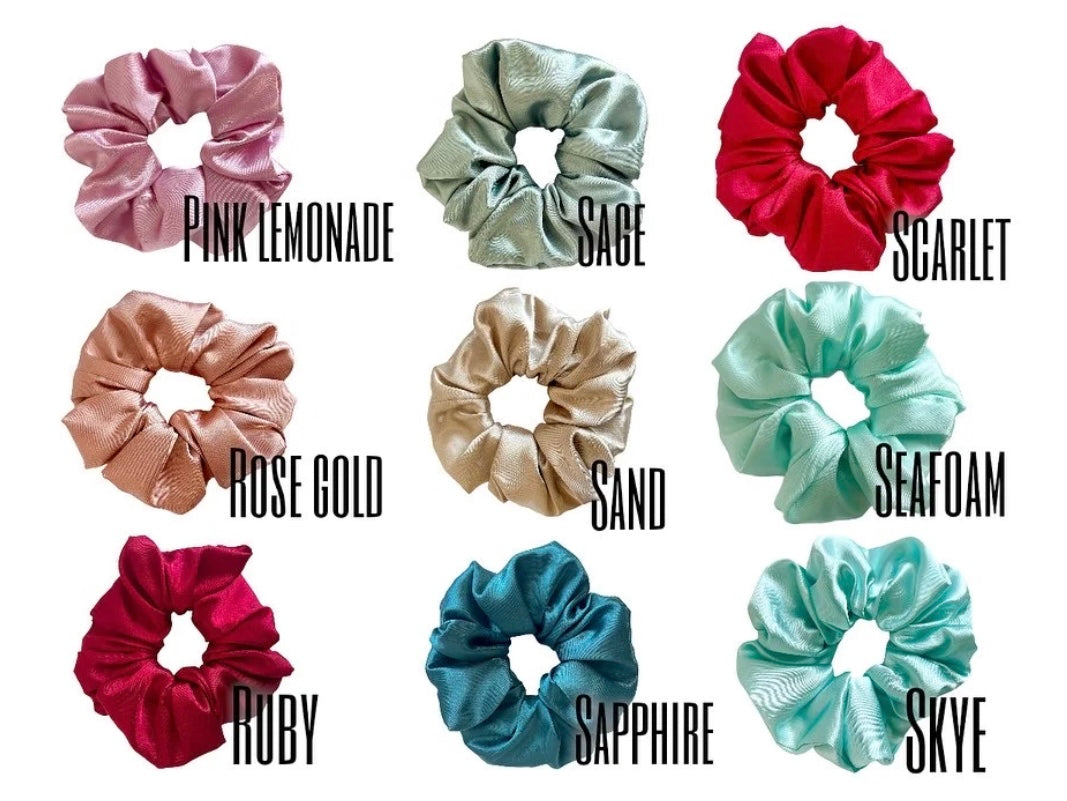 A collection of colorful sorority scrunchies featuring customizable letters, showcasing vibrant designs and soft fabric.