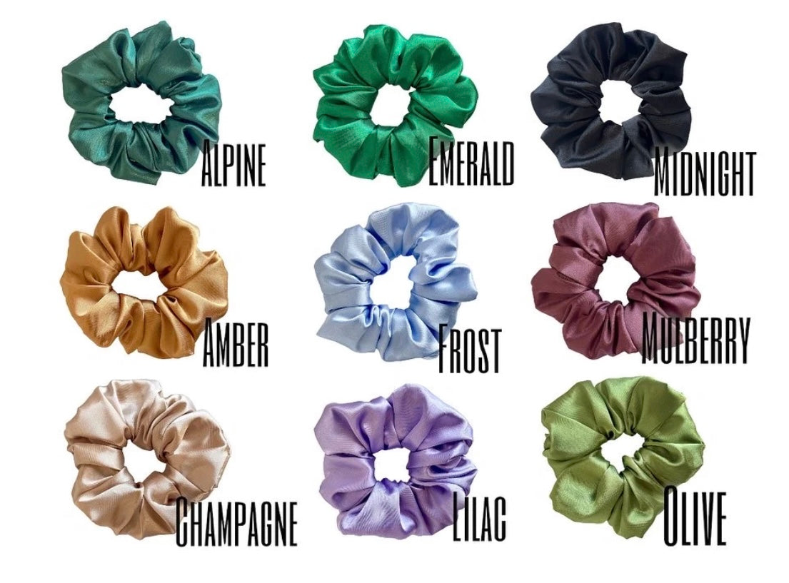 A collection of colorful sorority scrunchies featuring customizable letters, showcasing vibrant designs and soft fabric.