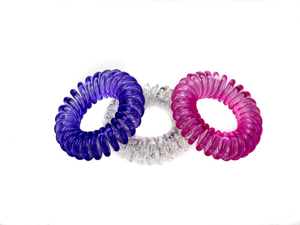 Sugar Twists® coil hair ties in various colors, showcasing their unique spiral design and eco-friendly materials.