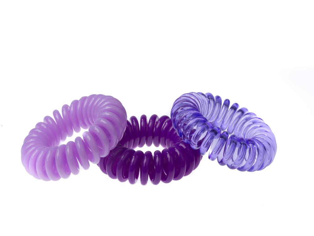 Sugar Twists® coil hair ties in various colors, showcasing their unique spiral design and eco-friendly materials.