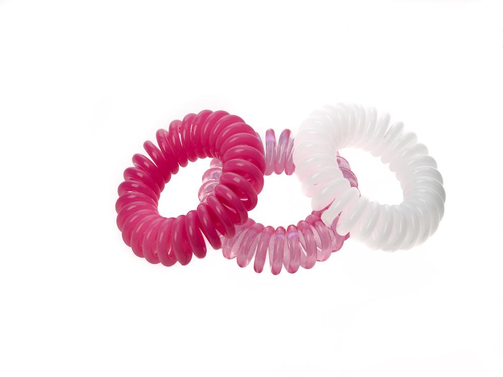 Sugar Twists® coil hair ties in various colors, showcasing their unique spiral design and eco-friendly materials.