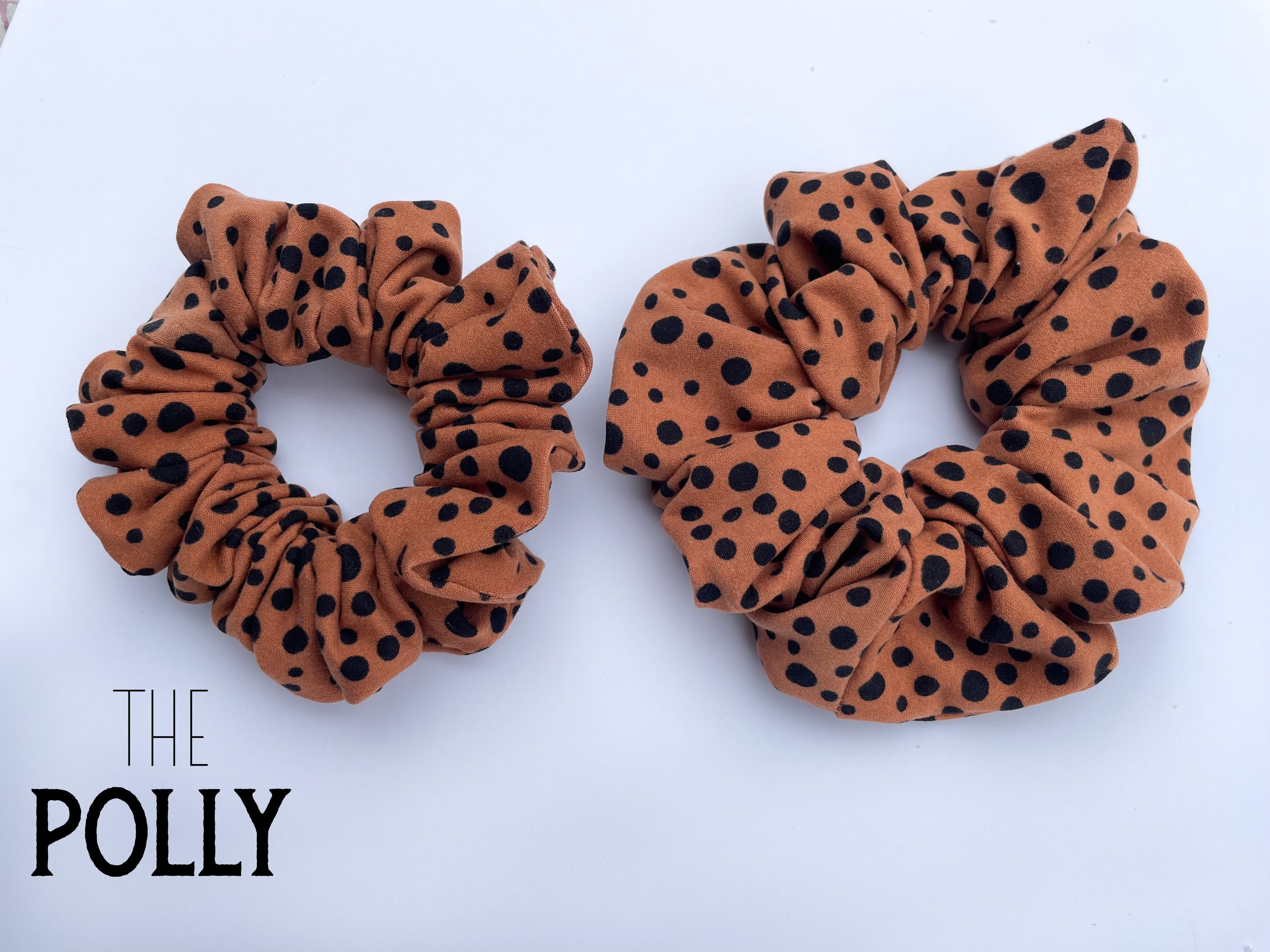 The POLLY knit scrunchie in various colors, showcasing its soft texture and stylish design.