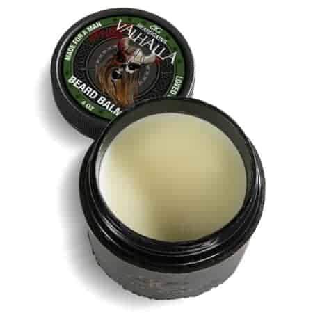 Valhalla Beard Balm in a stylish container, showcasing its glowing orange color and premium ingredients.