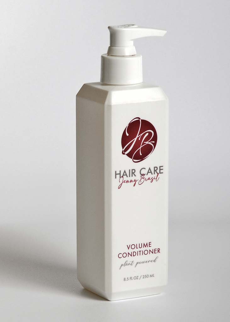 A bottle of VOLUME CONDITIONER showcasing its sleek design, perfect for enhancing hair volume and shine.