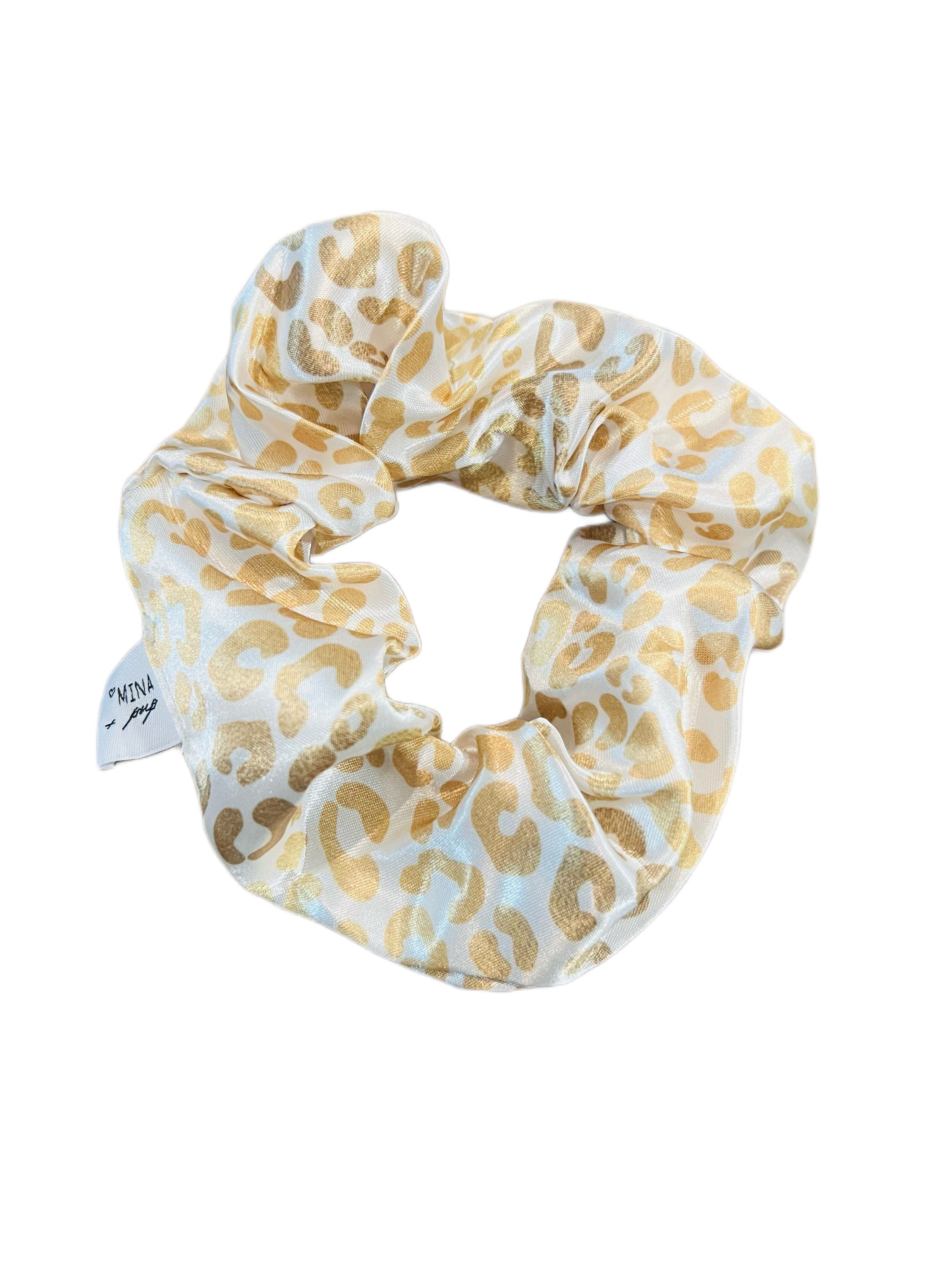 A luxurious silky hair scrunchie in a golden ombre design, perfect for stylish hairdos and matching with pets.