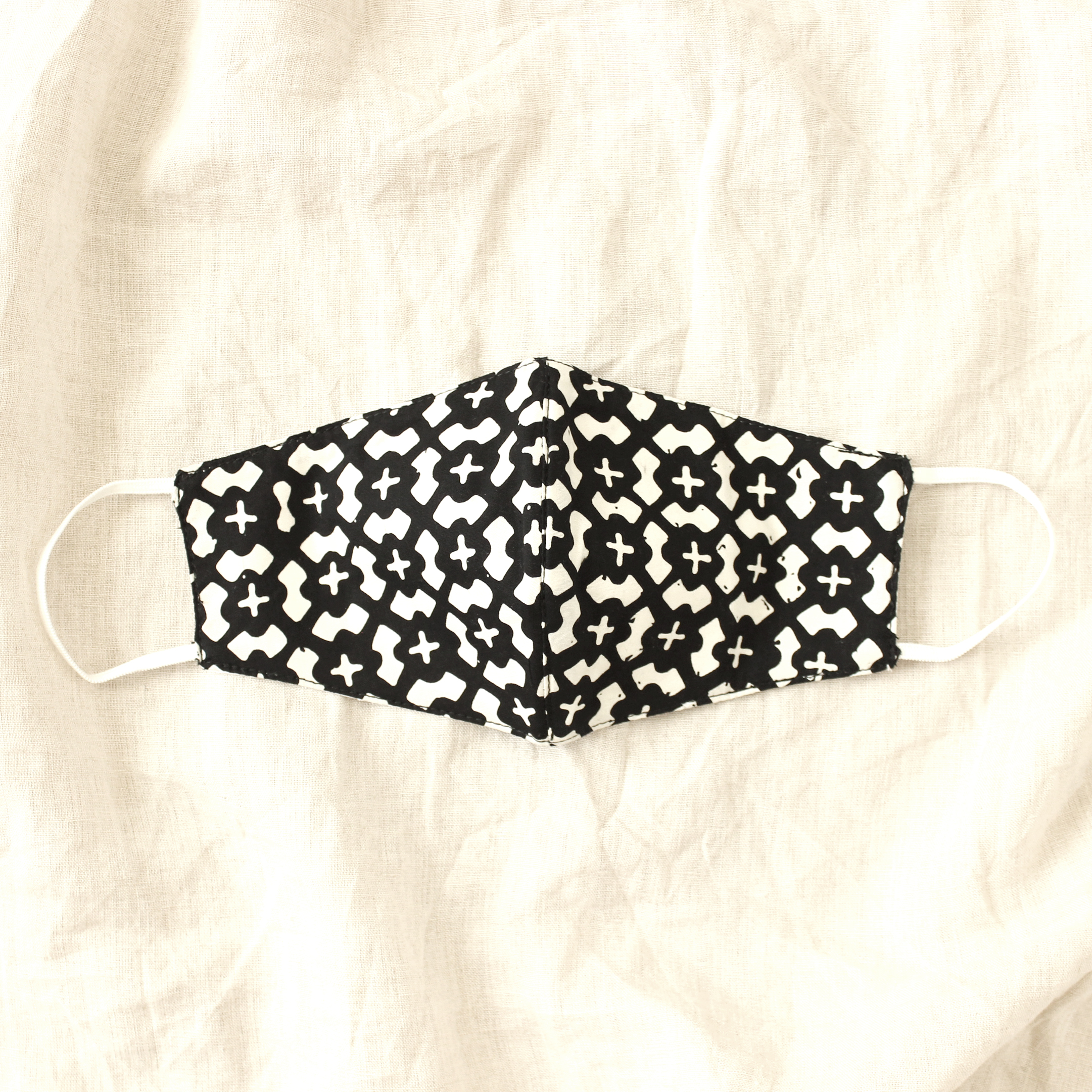 ARMOUR 3-ply Cup Batik Face Mask in Black, featuring vintage hand-stamped Batik fabric and elastic ear straps for a comfortable fit.