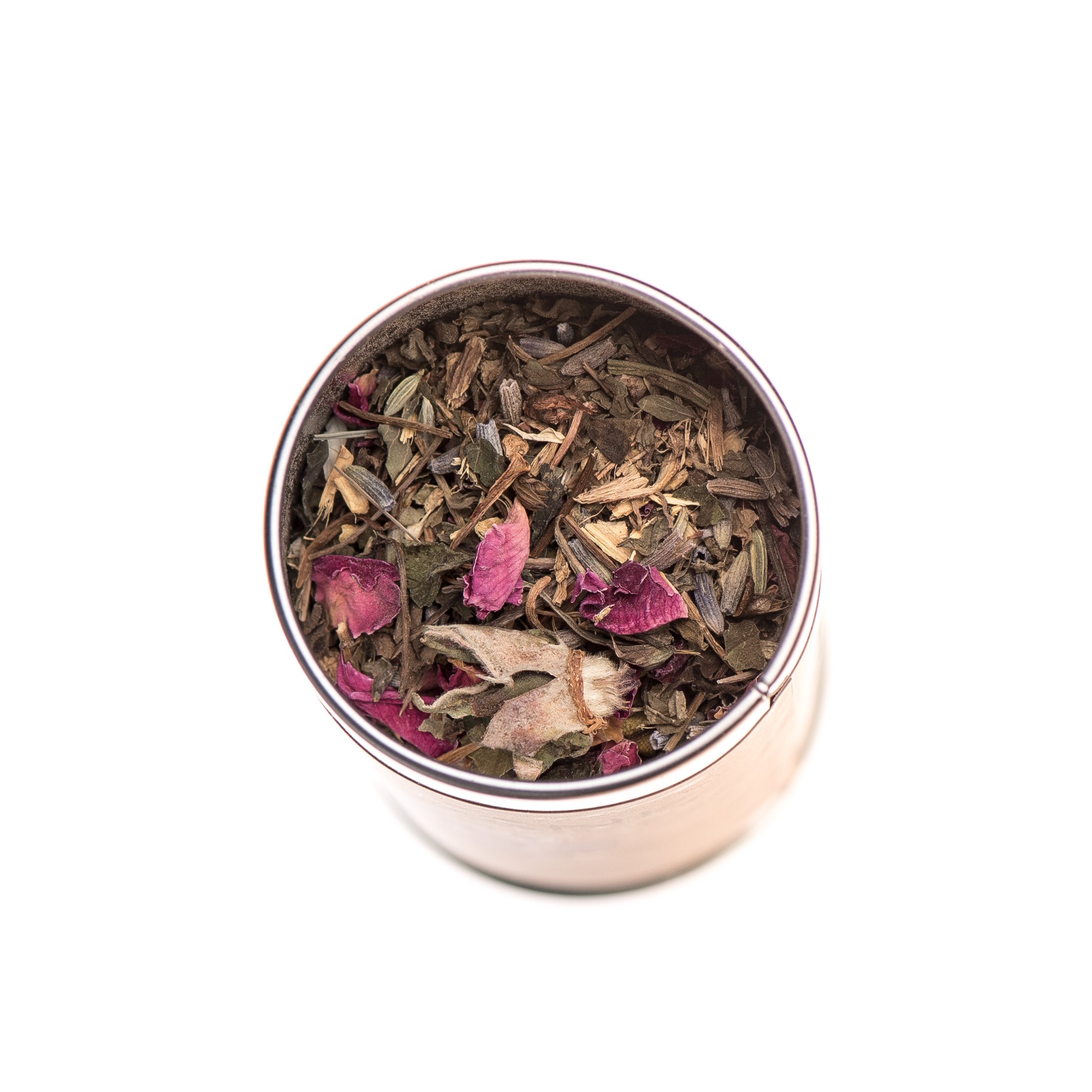 A beautifully arranged metal canister of Bliss Blend Tea, showcasing its vibrant herbal ingredients like Gotu Kola, Tulsi, and Rose, surrounded by calming floral elements.