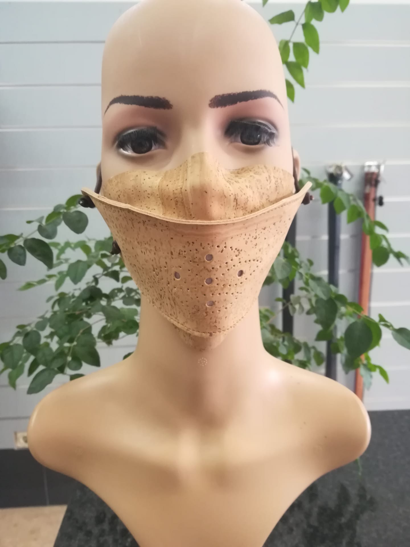 Eco-friendly cork face mask with adjustable ear loops, showcasing its lightweight and breathable design.