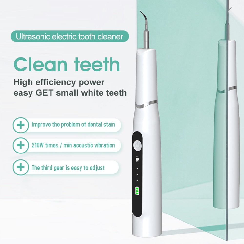 Electric Dental Calculus Remover with multiple cleaning heads and USB charging cable, designed for effective dental hygiene.