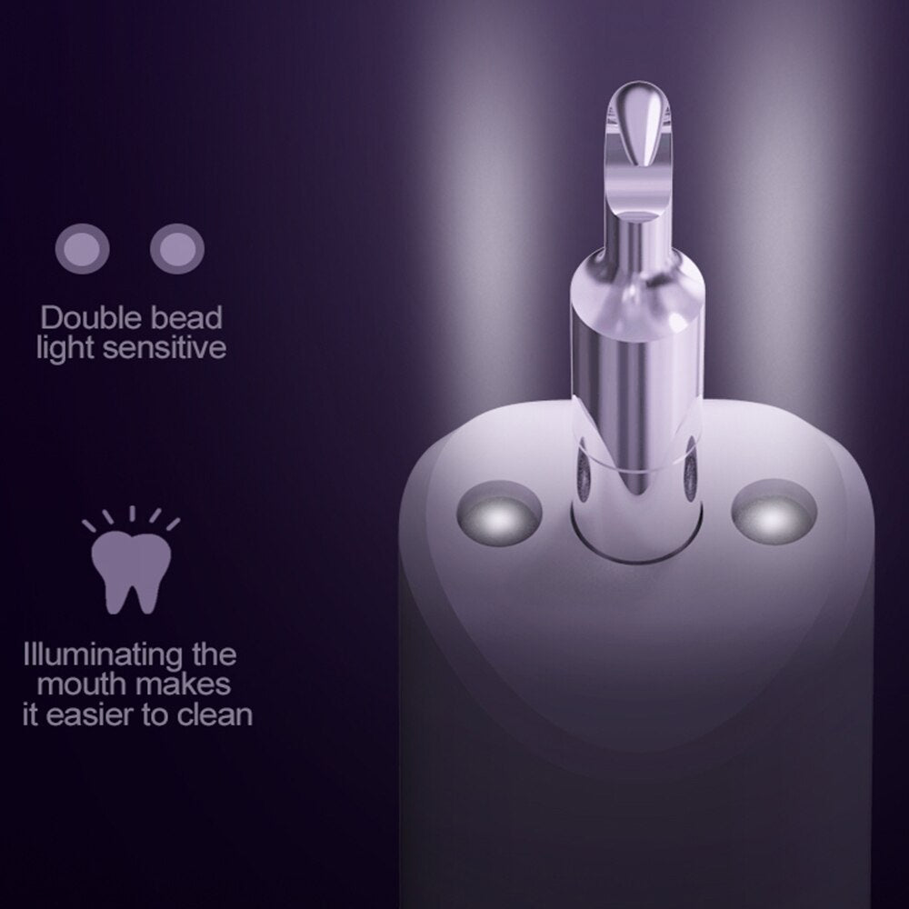 Electric Dental Calculus Remover with multiple cleaning heads and USB charging cable, designed for effective dental hygiene.