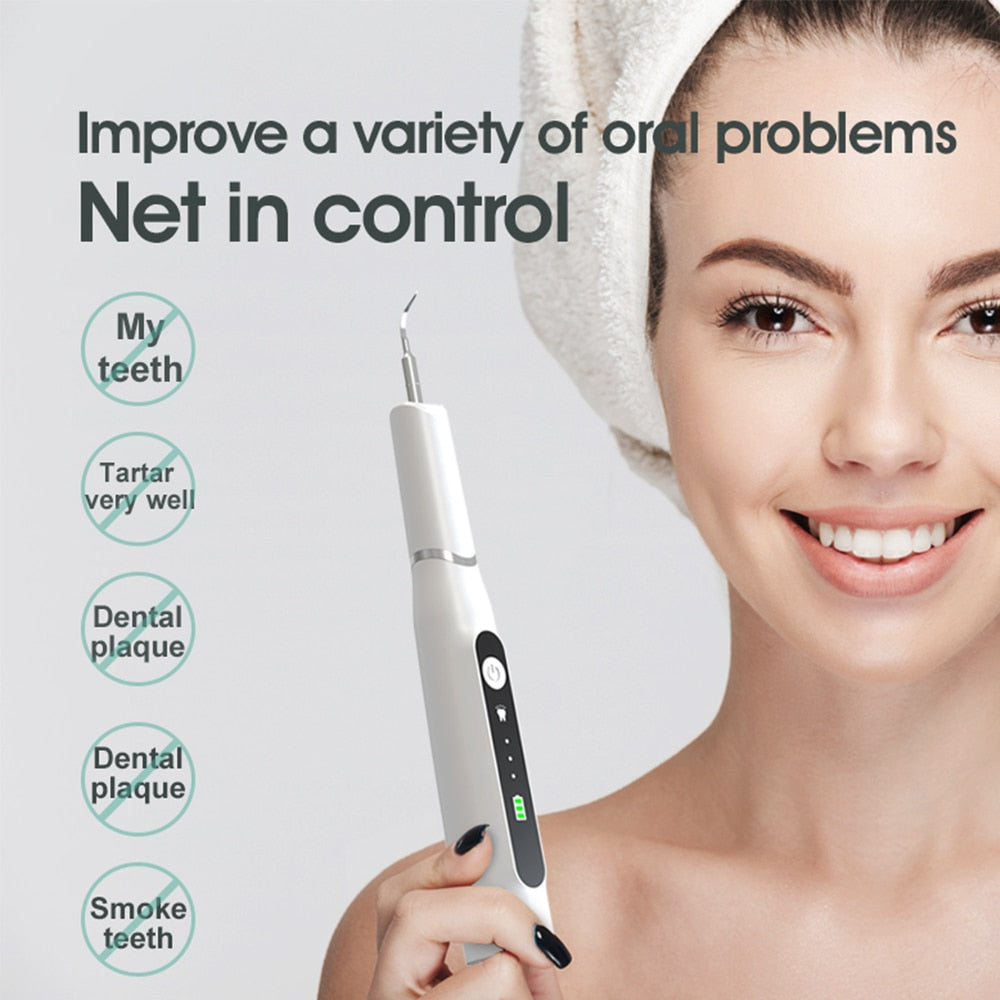 Electric Dental Calculus Remover with multiple cleaning heads and USB charging cable, designed for effective dental hygiene.