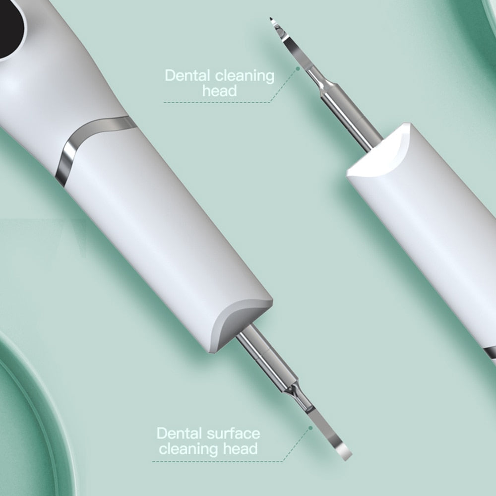 Electric Dental Calculus Remover with multiple cleaning heads and USB charging cable, designed for effective dental hygiene.