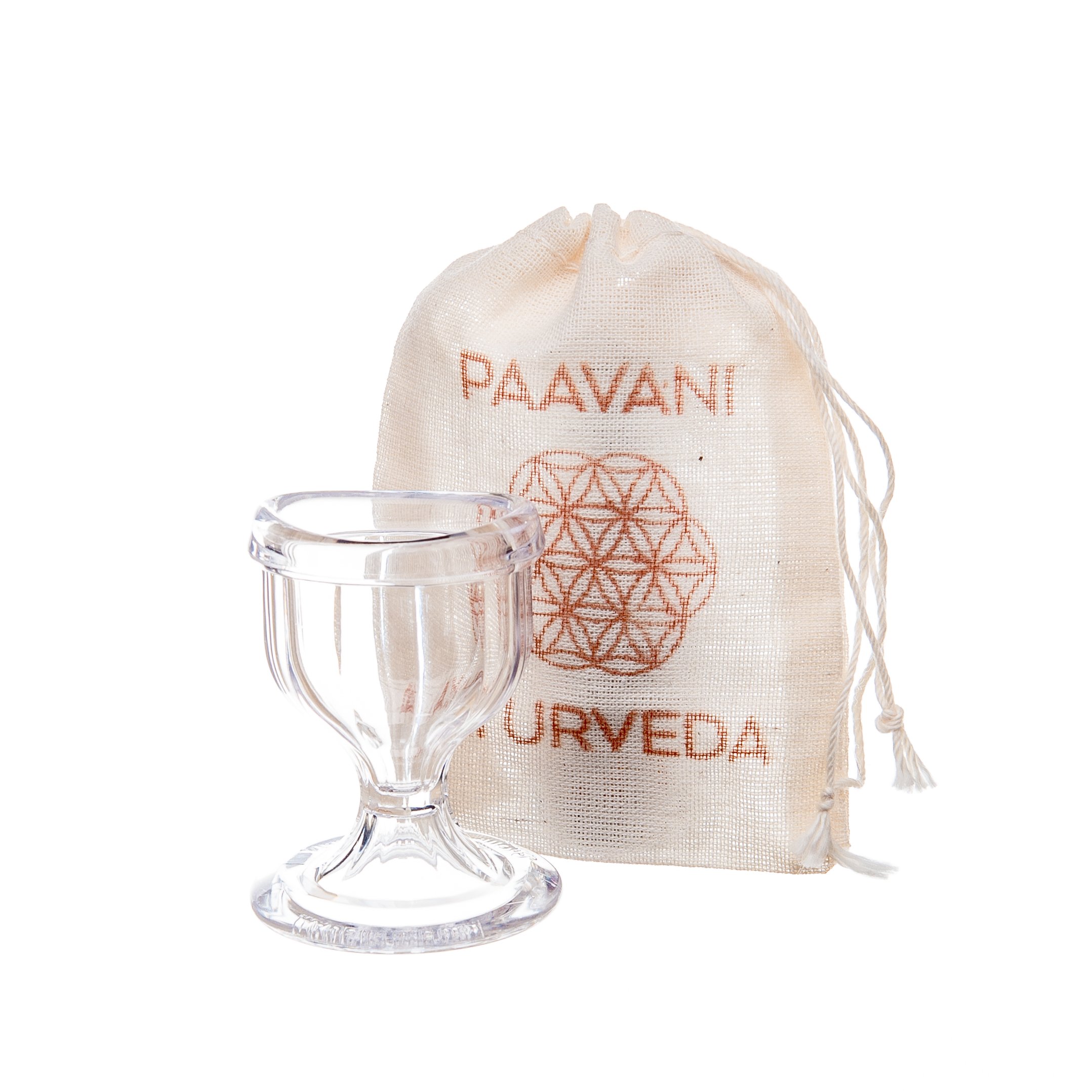 A clear glass eye wash cup designed for soothing and hydrating tired eyes, accompanied by a muslin travel bag for convenience.